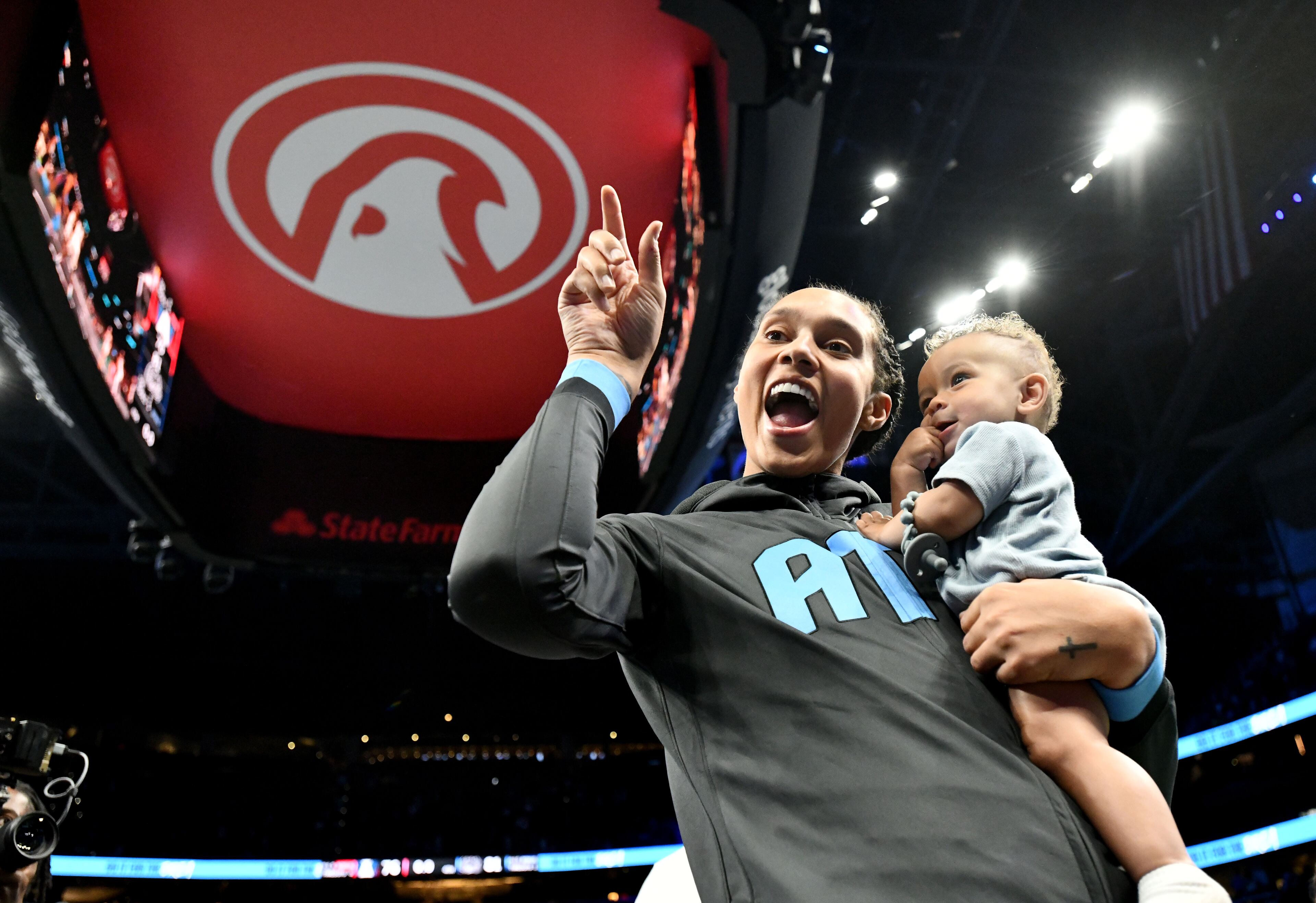Atlanta Dream center Brittney Griner (42) holds her son Bash after Indiana Fever beat Atlanta Dream during Atlanta Dream’s home opener at State Farm Arena, Thursday, May 22, 2025, in Atlanta. Indiana Fever won 81-76 over Atlanta Dream. (Hyosub Shin / AJC)