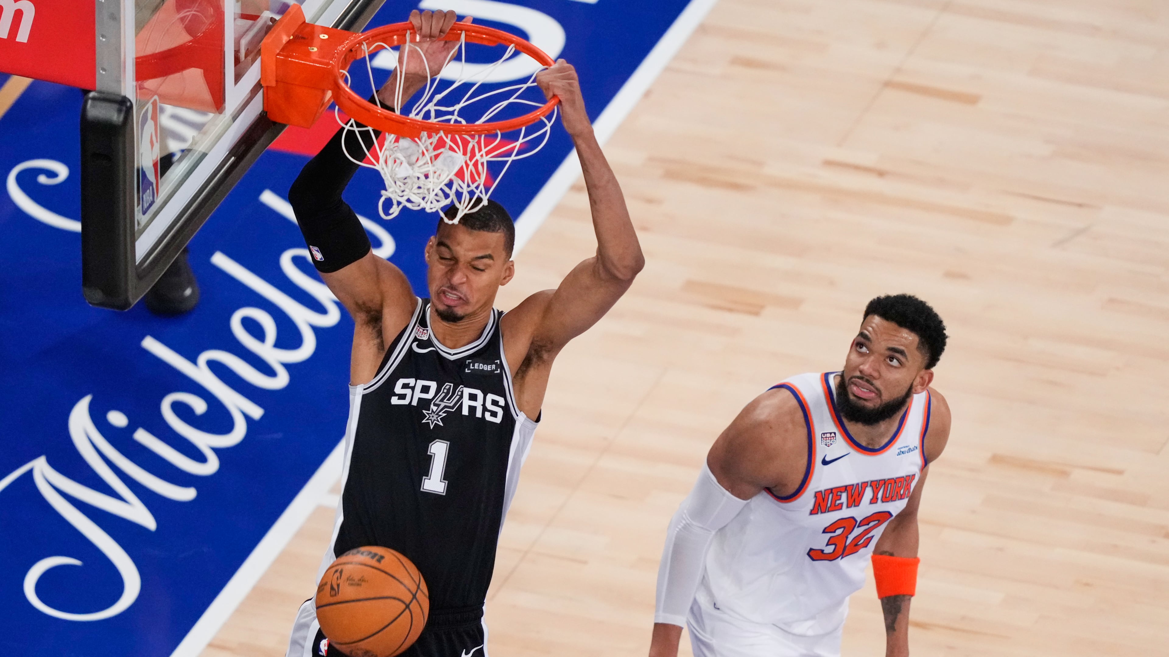 San Antonio Spurs forward Victor Wembanyama (1) dunks as New York Knicks center Karl-Anthony Towns (32) looks on during the second half of Game 3 of the NBA Finals basketball series, Monday, June 8, 2026, in New York. (AP Photo/Yuki Iwamura)