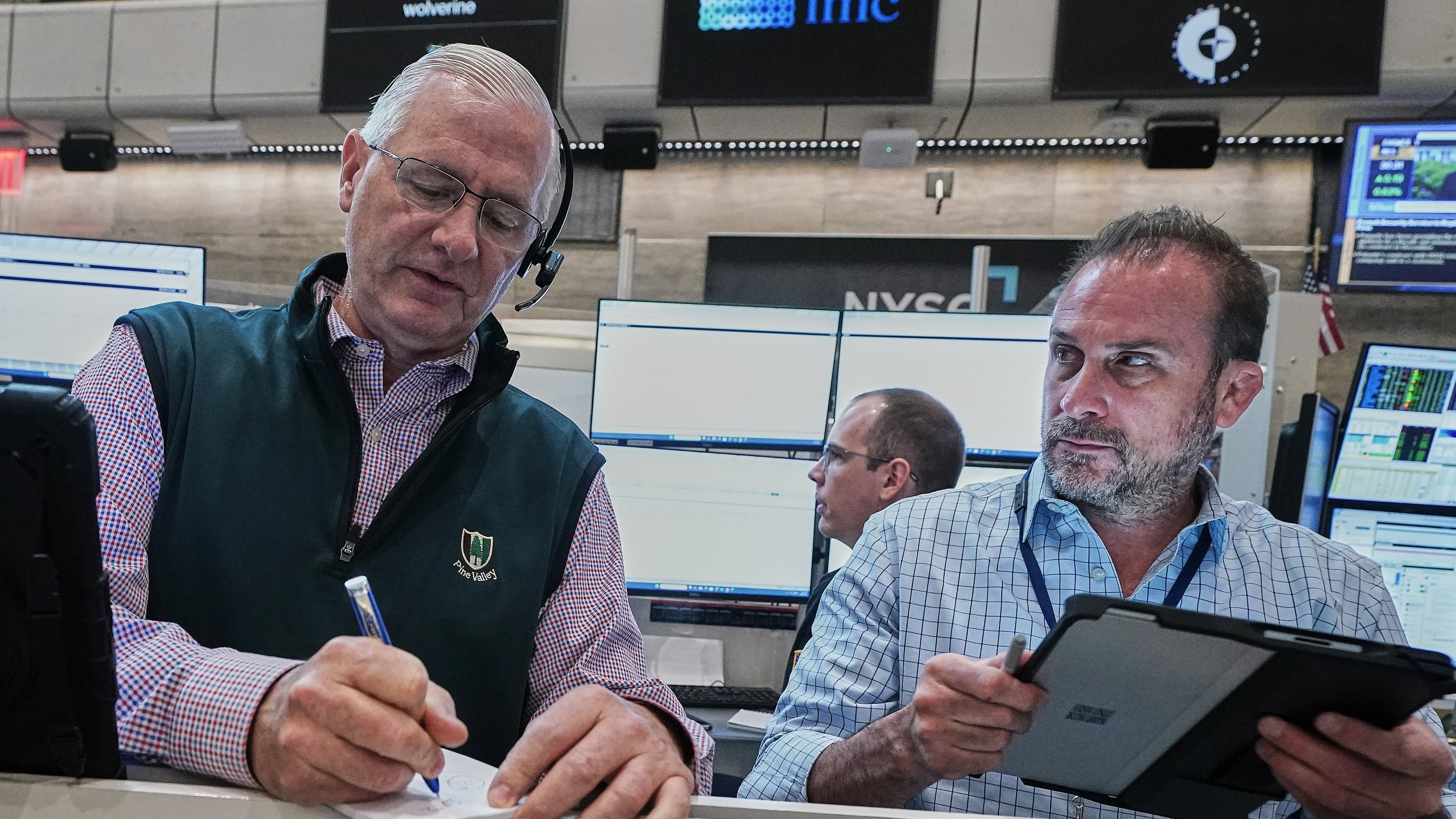 Options traders David Rush, left, and Scott Frinzi work on the floor of the New York Stock Exchange, Tuesday, June 16, 2026. (AP Photo/Richard Drew)
