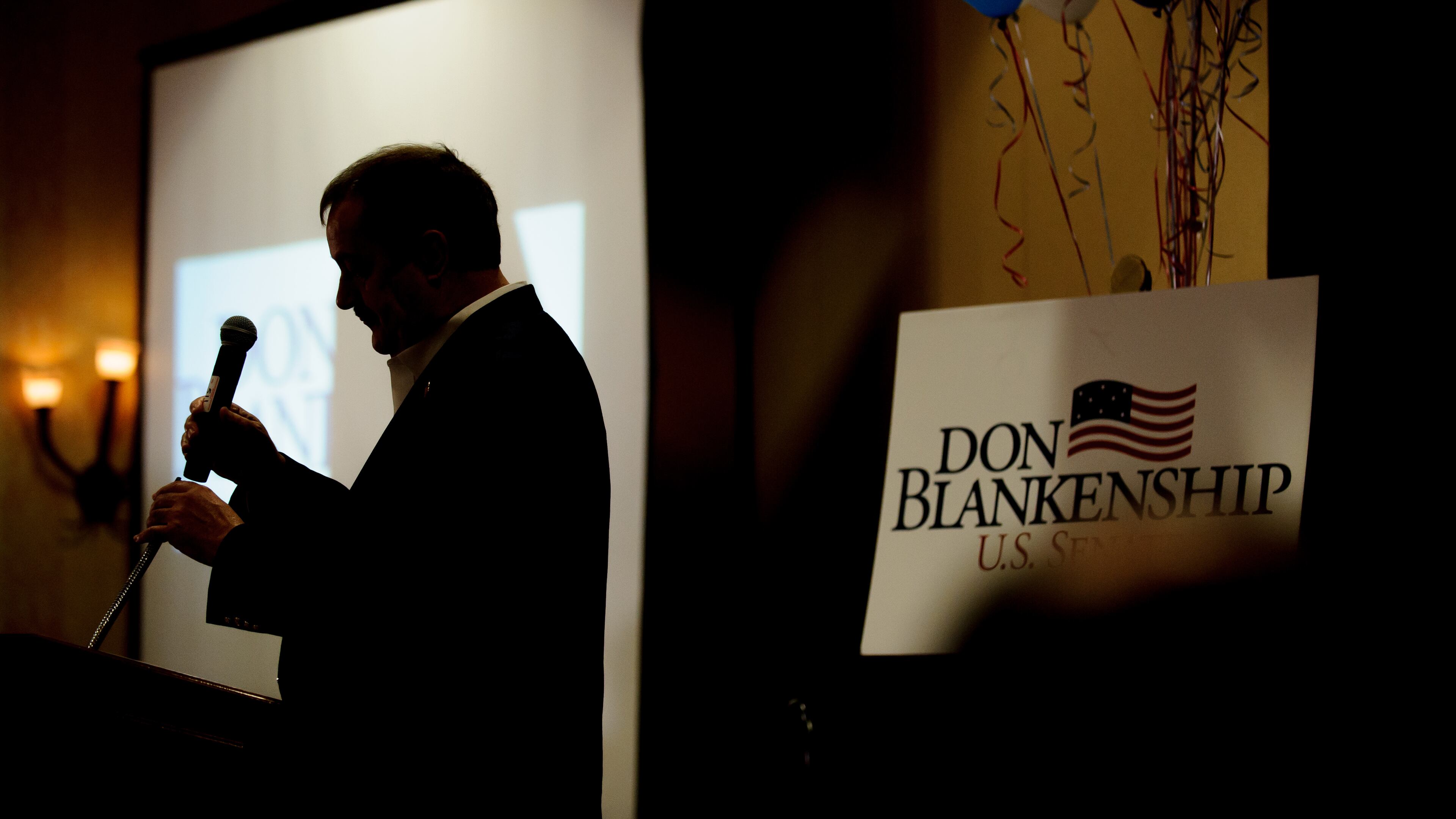 Don Blankenship, a Republican primary candidate for the U.S. Senate in West Virginia, replaces the microphone after addressing supporters on Tuesday. Jeff Swensen/Getty Images