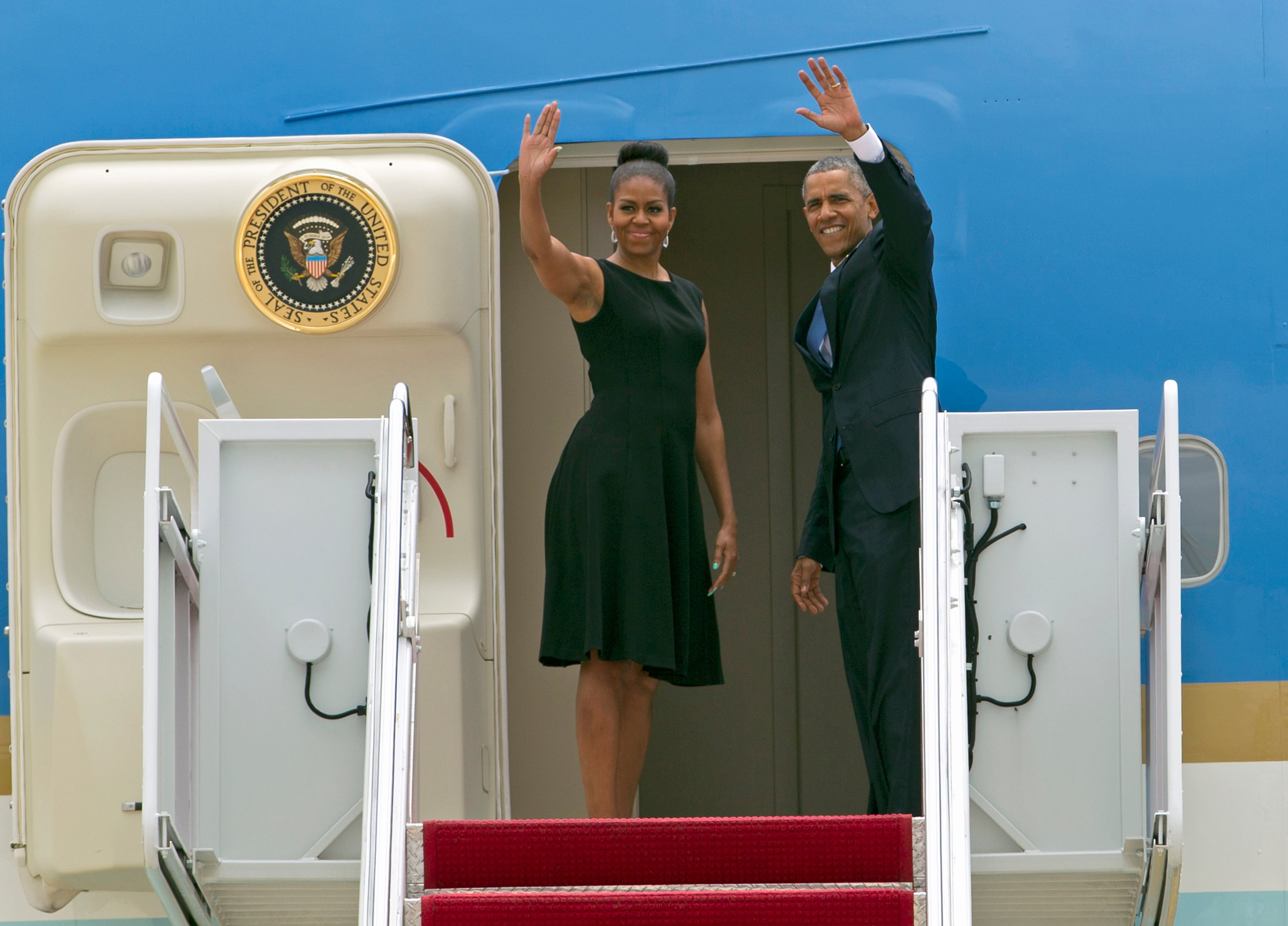 President Barack Obama and first lady Michelle Obama wave prior to boarding Air Force One, before their departure at Andrews Air Force Base, Md., on Friday, June 26, 2015, en route to Charleston, S.C., to attend services honoring the life of Reverend Clementa Pinckney at the College of Charleston TD Arena. Pinckney was one of the nine people killed in the shooting at Emanuel AME Church last week in Charleston.(AP Photo/Jose Luis Magana)