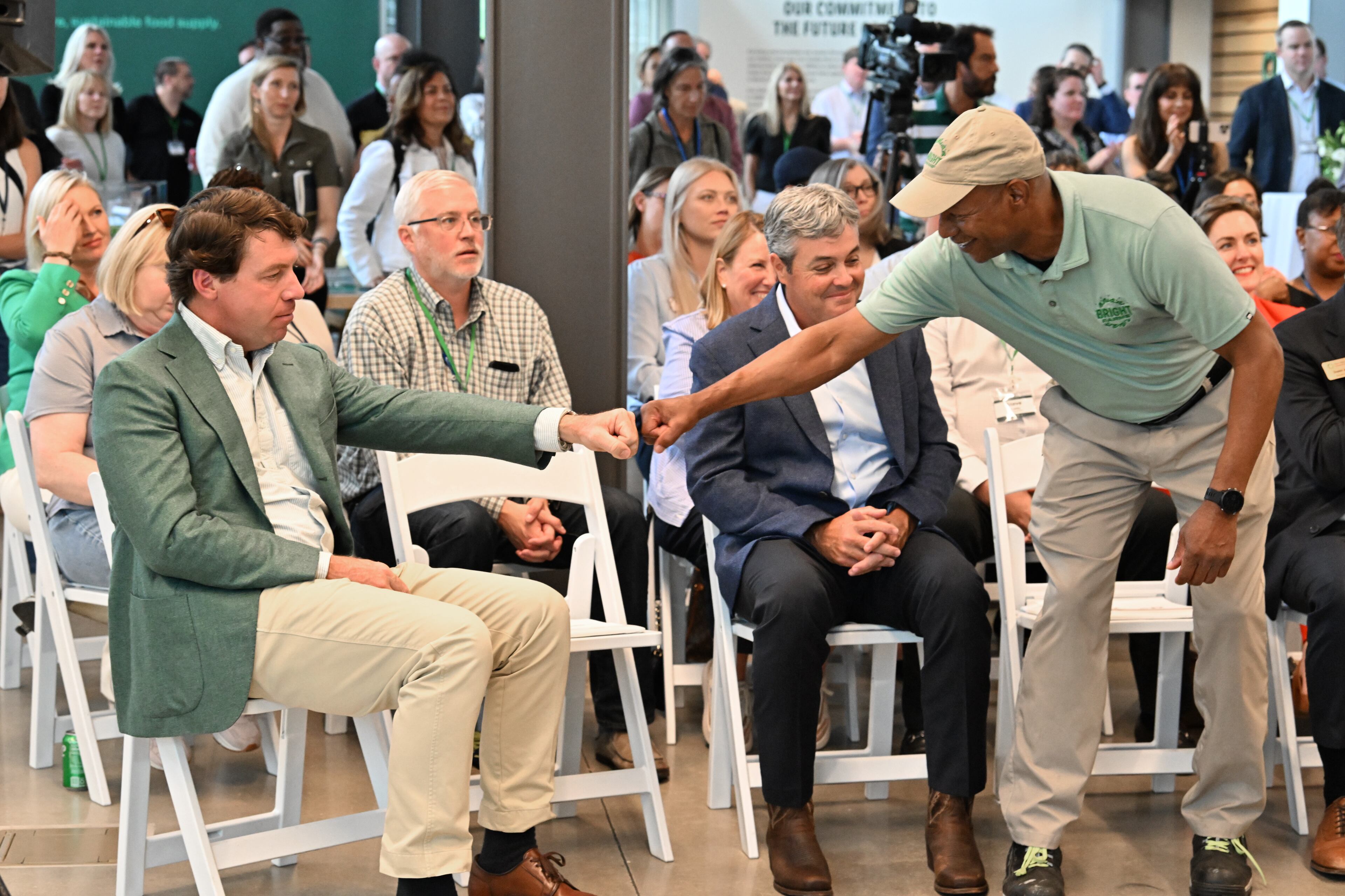 “If my great-grandfather were alive today, he would be the happiest person in this room, because we’re back on a farm,” Cox Enterprises Chairman and CEO Alex Taylor (left) said during the grand opening, in which he and Kelvin Hill, general manager of BrightFarms's Macon greenhouse, bumped fists. (Hyosub Shin/AJC)