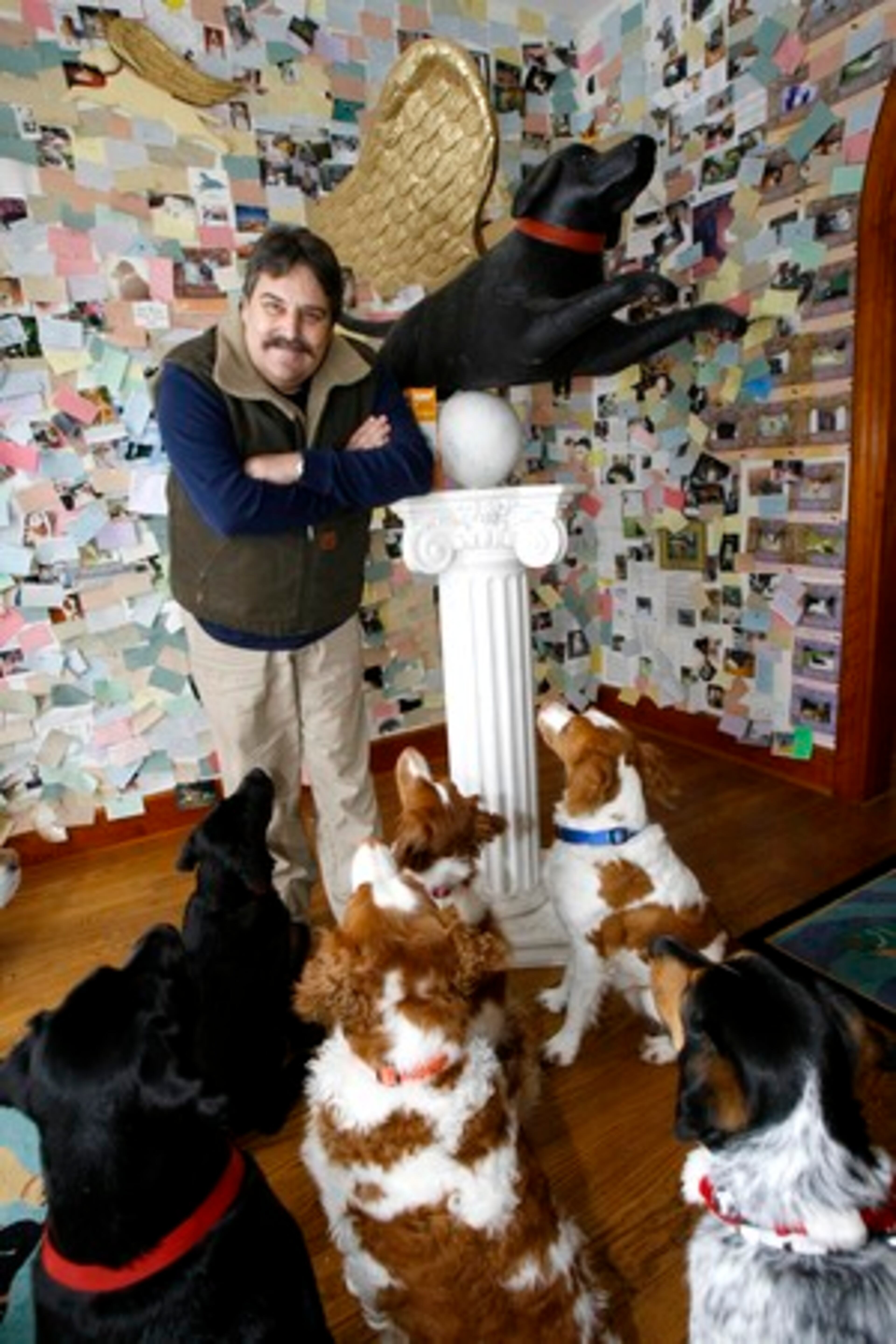 Vermont folk artist Stephen Huneck poses in his dog chapel in St. Johnsbury, Vt.