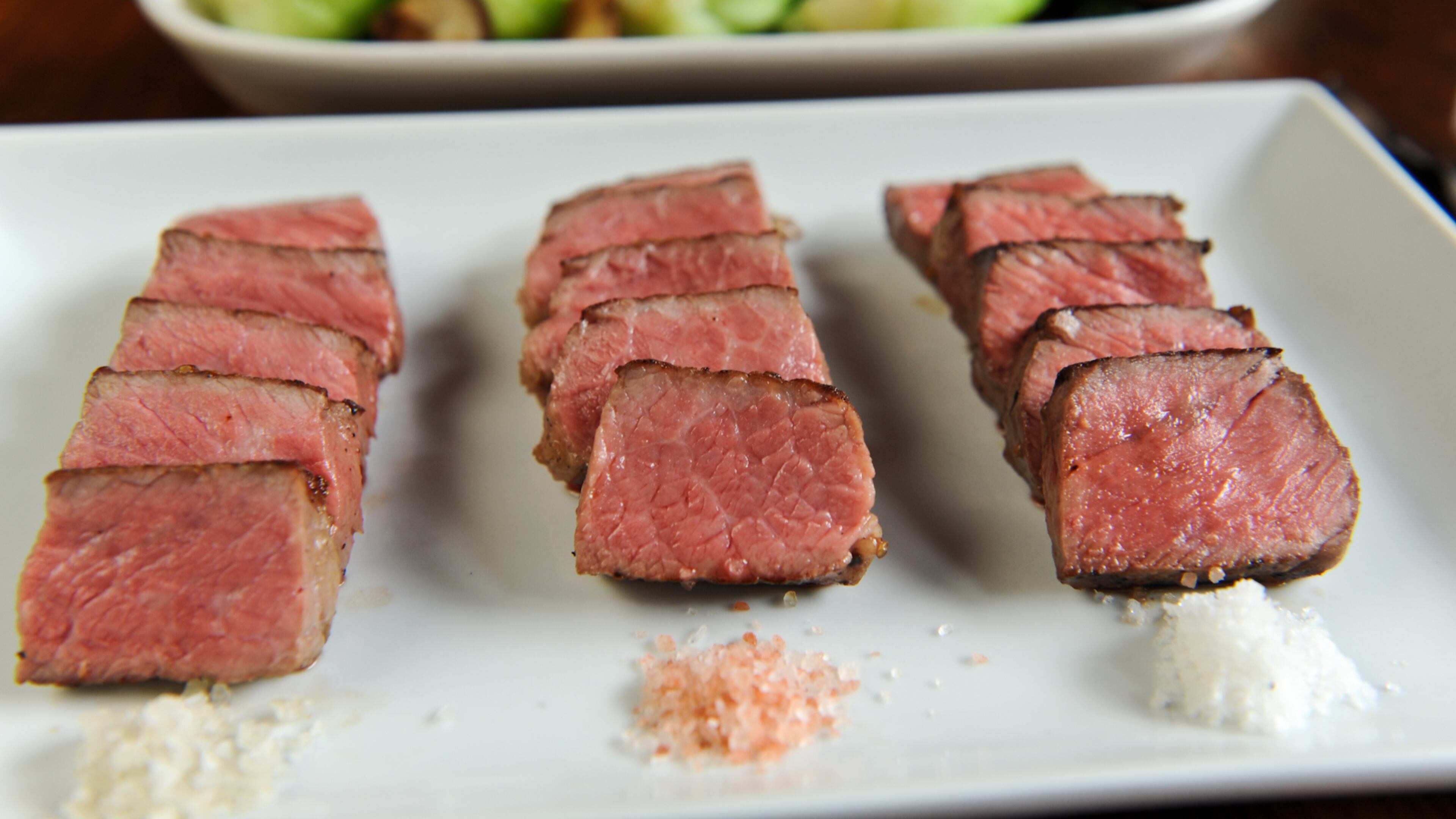 Progression of New York Strip- 4 oz of each : wet-aged USDA Angus beef, USDA Prime beef, Dry-aged USDA Angus beef. Served with a side of Bok Choy -shiitake mushrooms, oyster sauce. (BECKY STEIN/special)