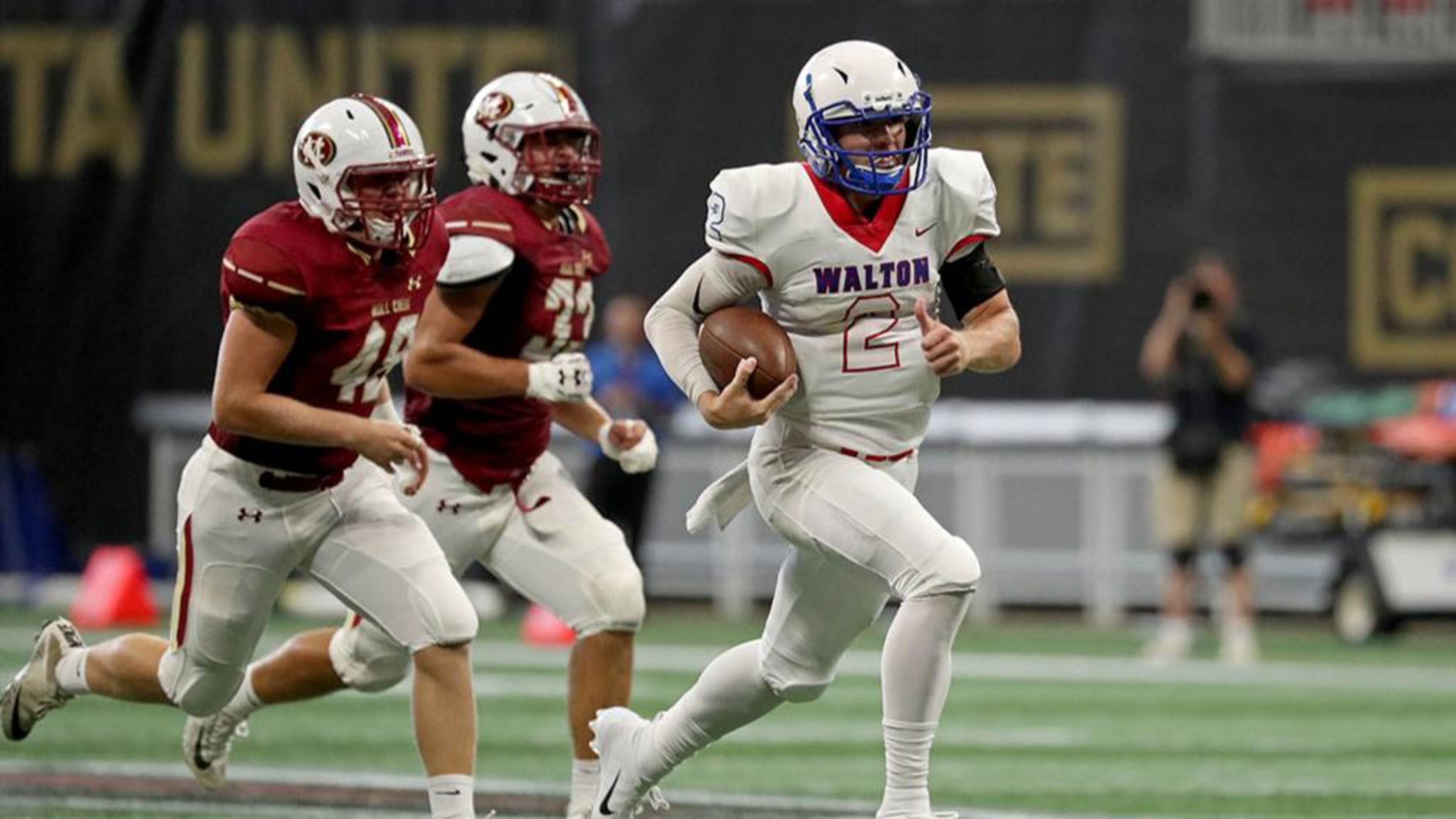 Walton quarterback Austin Kirksey (2) runs for a first down in the second half against Mill Creek during the Corky Kell Classic game Saturday, Aug. 18, 2018, at Mercedes-Benz Stadium in Atlanta.