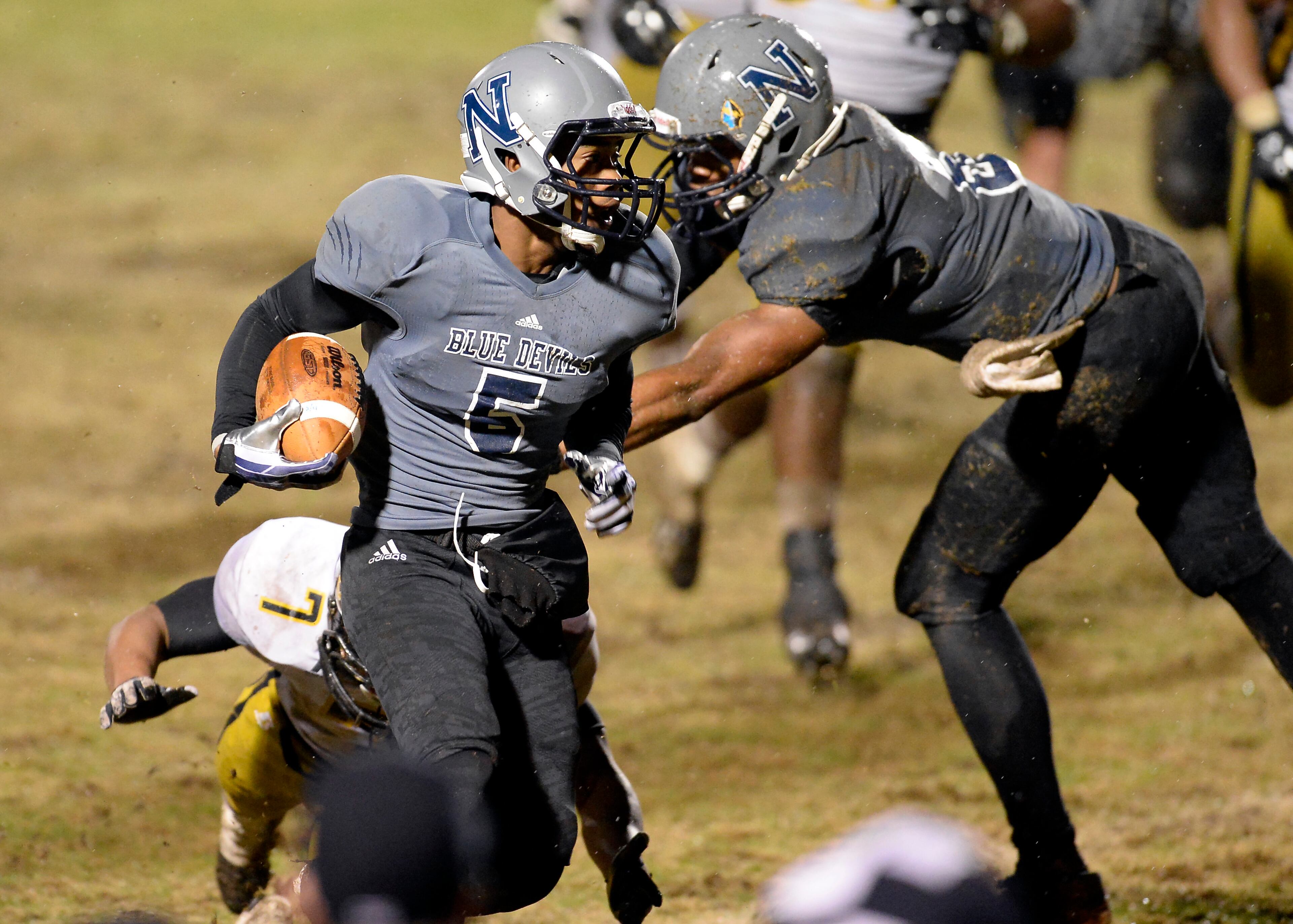Norcross running back Miles Autry (5) evades a tackle by Colquitt's O'Shay Williams on a long run for a touchdown that put Norcross ahead 13-9 before the PAT in the second half of their AAAAAA semifinal game at Blue Devil Stadium on Friday, Dec. 6, 2013, in Norcross, Ga.
