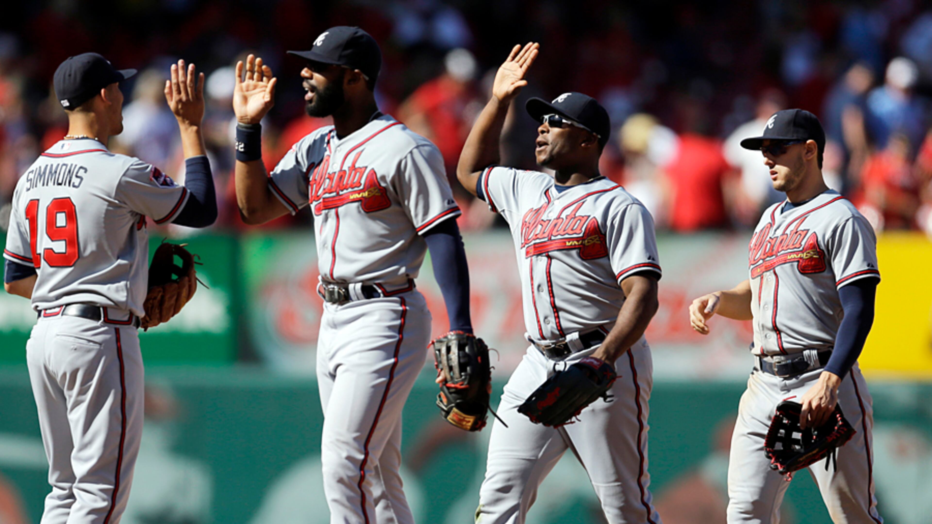 Atlanta Braves, from left, Andrelton Simmons, Jason Heyward, Justin Upton and Jordan Schafer celebrate after defeating the St. Louis Cardinals 6-5 in a baseball game Sunday, May 18, 2014, in St. Louis. (AP Photo/Jeff Roberson)