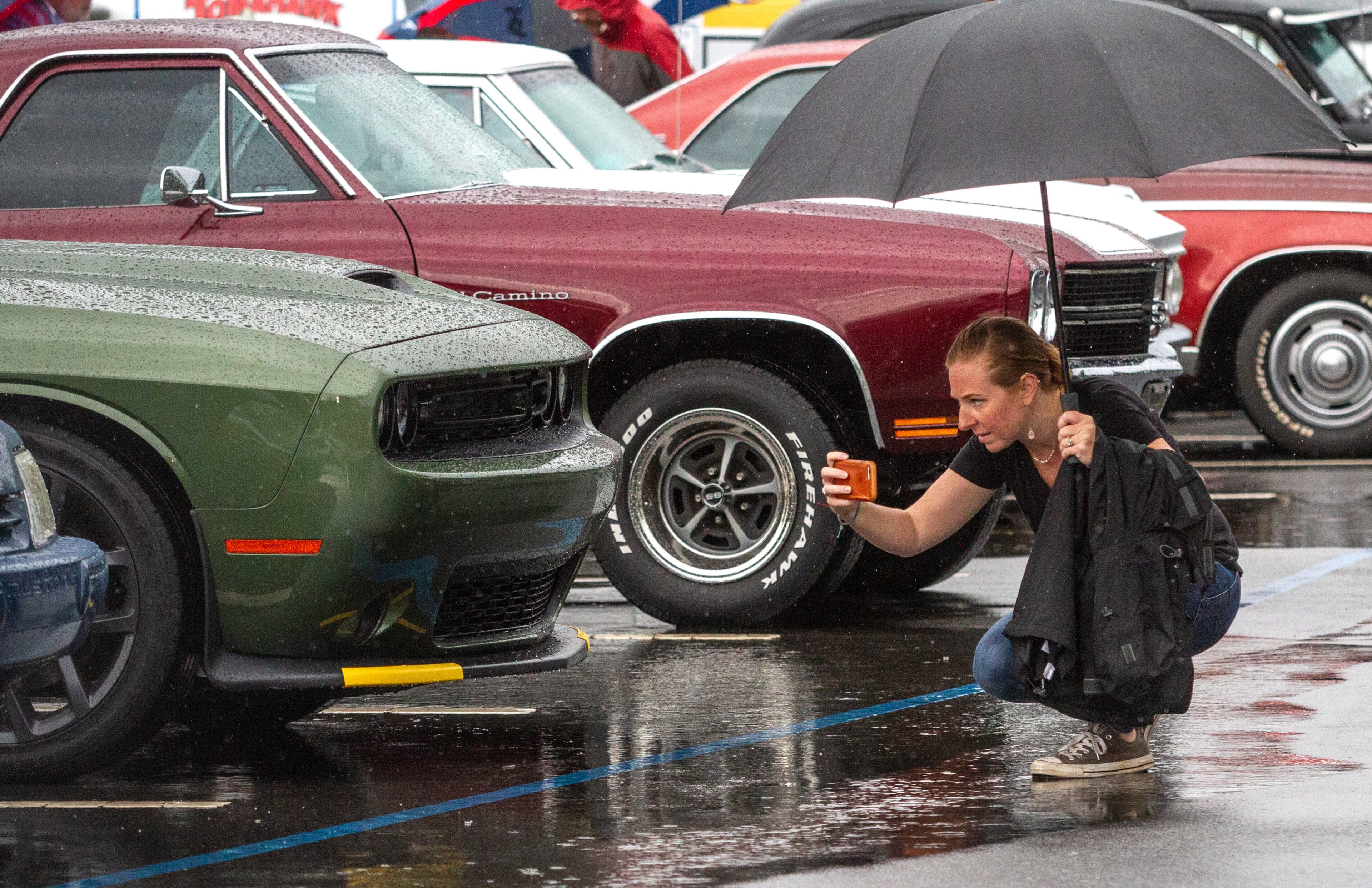 Michelle Abbott takes photos of some of the cars during the Creepers Car Club’s 29th annual charity show in Marietta on Sunday, June 8, 2019. STEVE SCHAEFER / SPECIAL TO THE AJC
