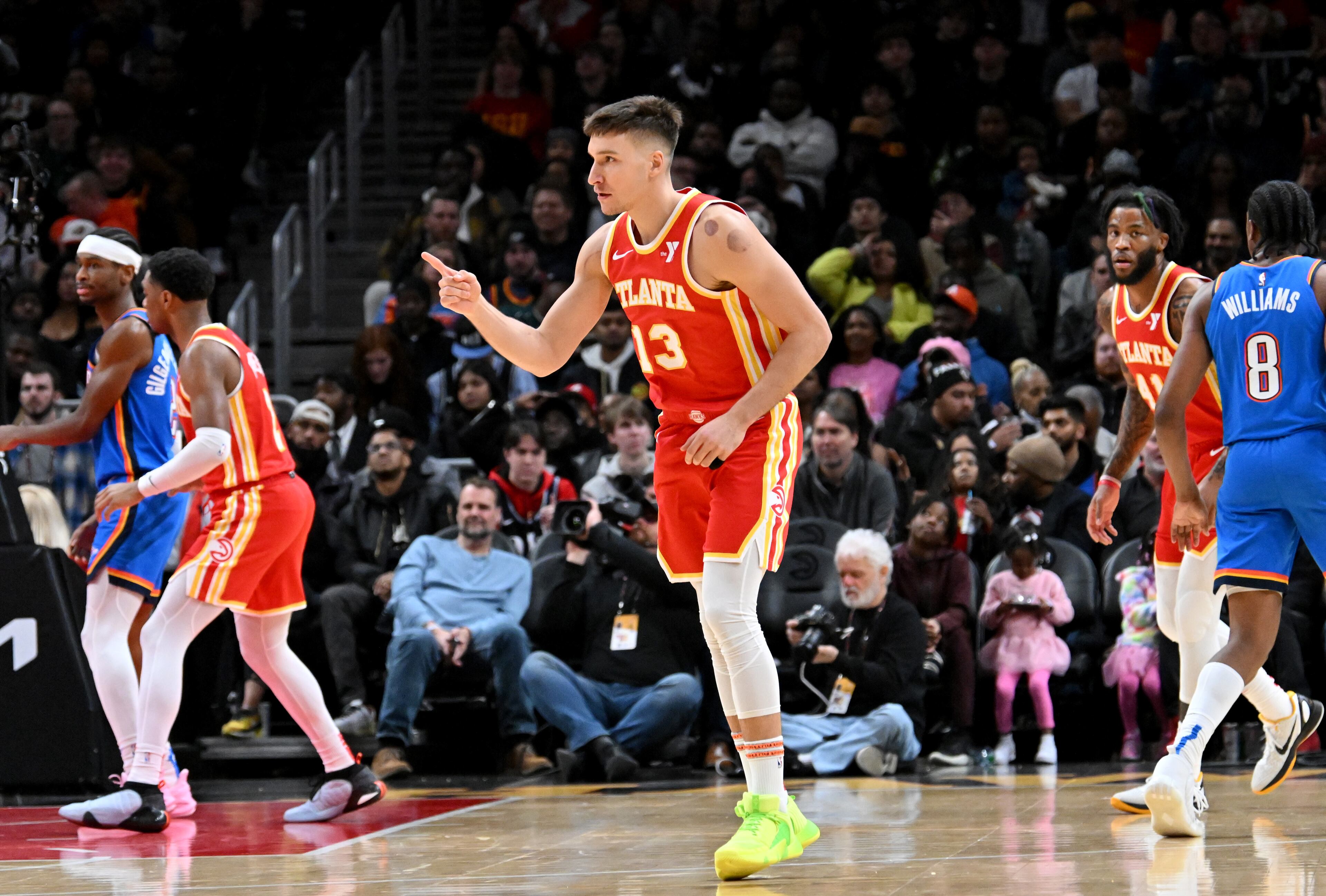 Atlanta Hawks guard Bogdan Bogdanovic (13) reacts after scoring a 3-point basket during the second half in an NBA basketball game at State Farm Arena, Wednesday, December 3, 2024, in Atlanta. Atlanta Hawks won 141-138 over Oklahoma City Thunder. (Hyosub Shin / Hyosub.Shin@ajc.com)