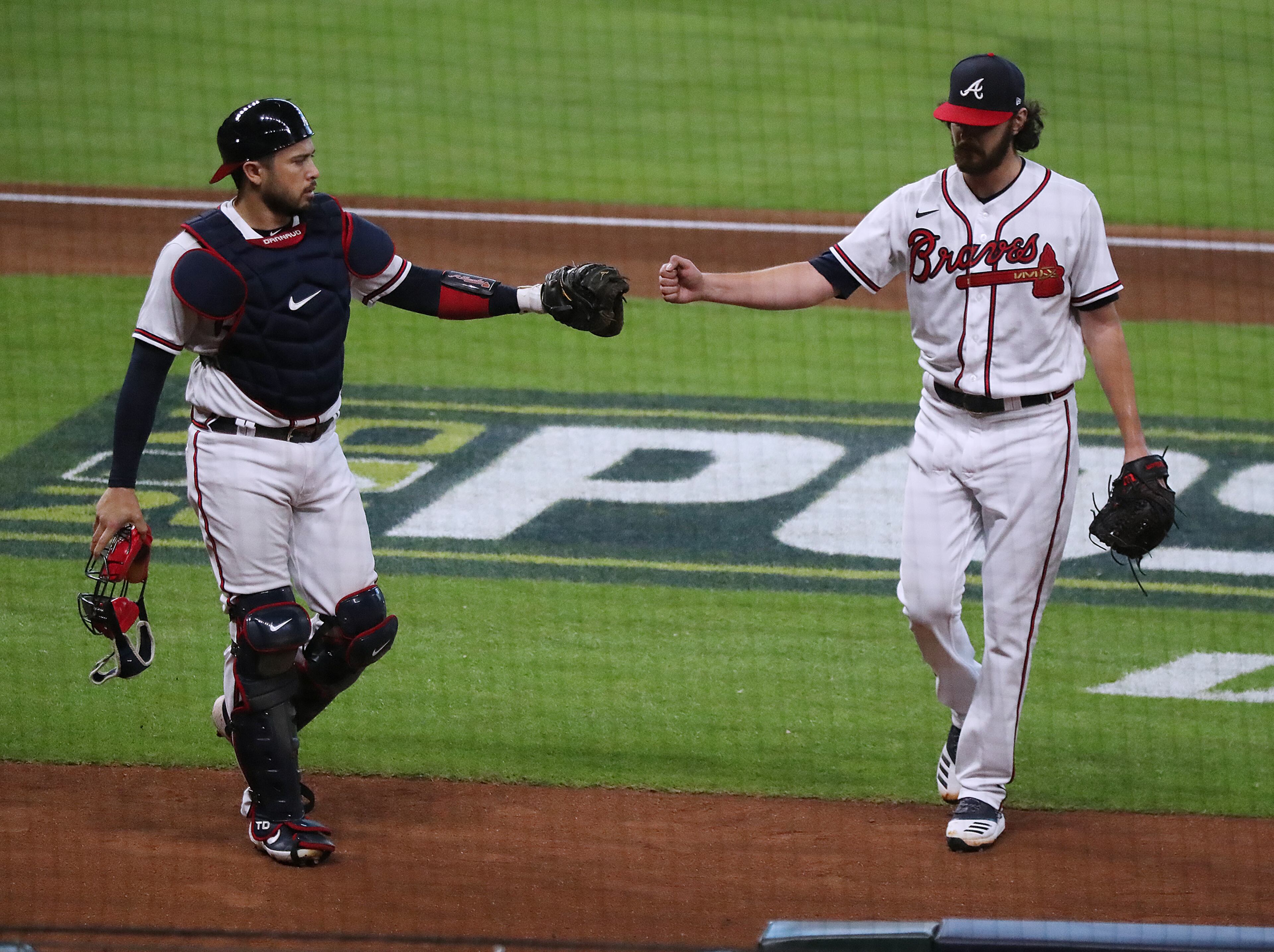 Atlanta Braves catcher Travis d’Arnaud gives starting pitcher Ian Anderson a glove bump against the Miami Marlins in Game 2 of a National League Division Series at Minute Maid Park on Wednesday, Oct 7, 2020 in Houston. Anderson went 5 2/3 innings in a 2-0 victory over the Marlins for a 2 game to none lead in the series. “Curtis Compton / Curtis.Compton@ajc.com”