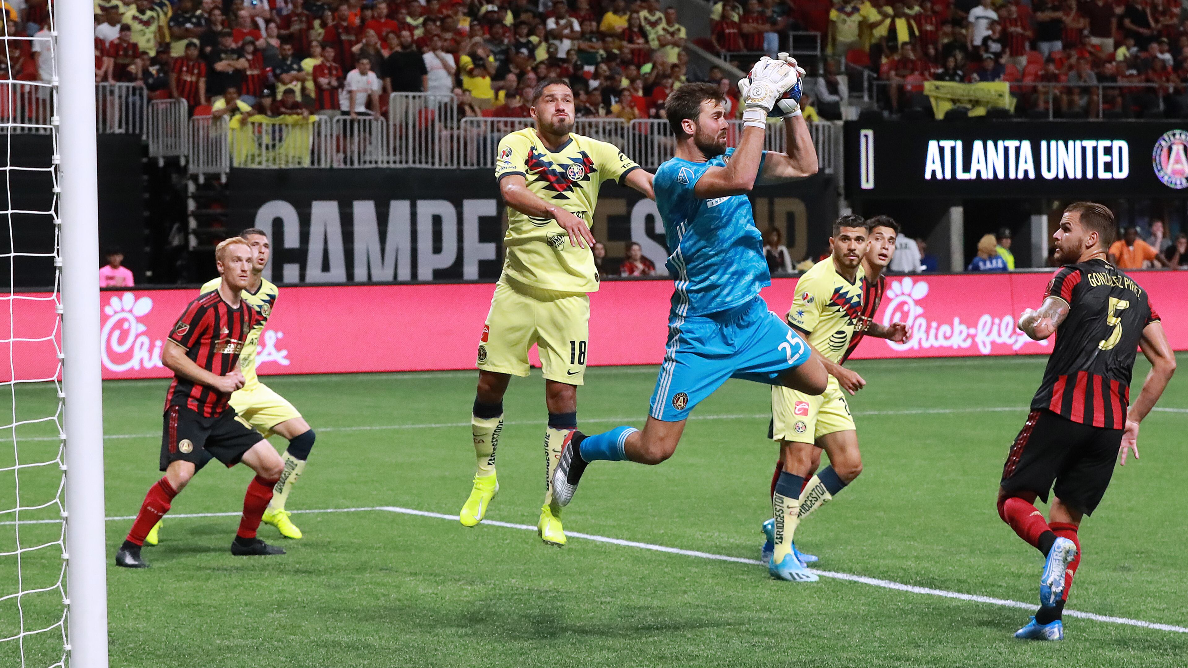 August 14, 2019 Atlanta: Atlanta United goalkeeper Alec Kann blocks a shot by Club America in front of Bruno Valdez during the first half in the Campeones Cup on Wednesday, August 14, 2019, in Atlanta. Curtis Compton/ccompton@ajc.com