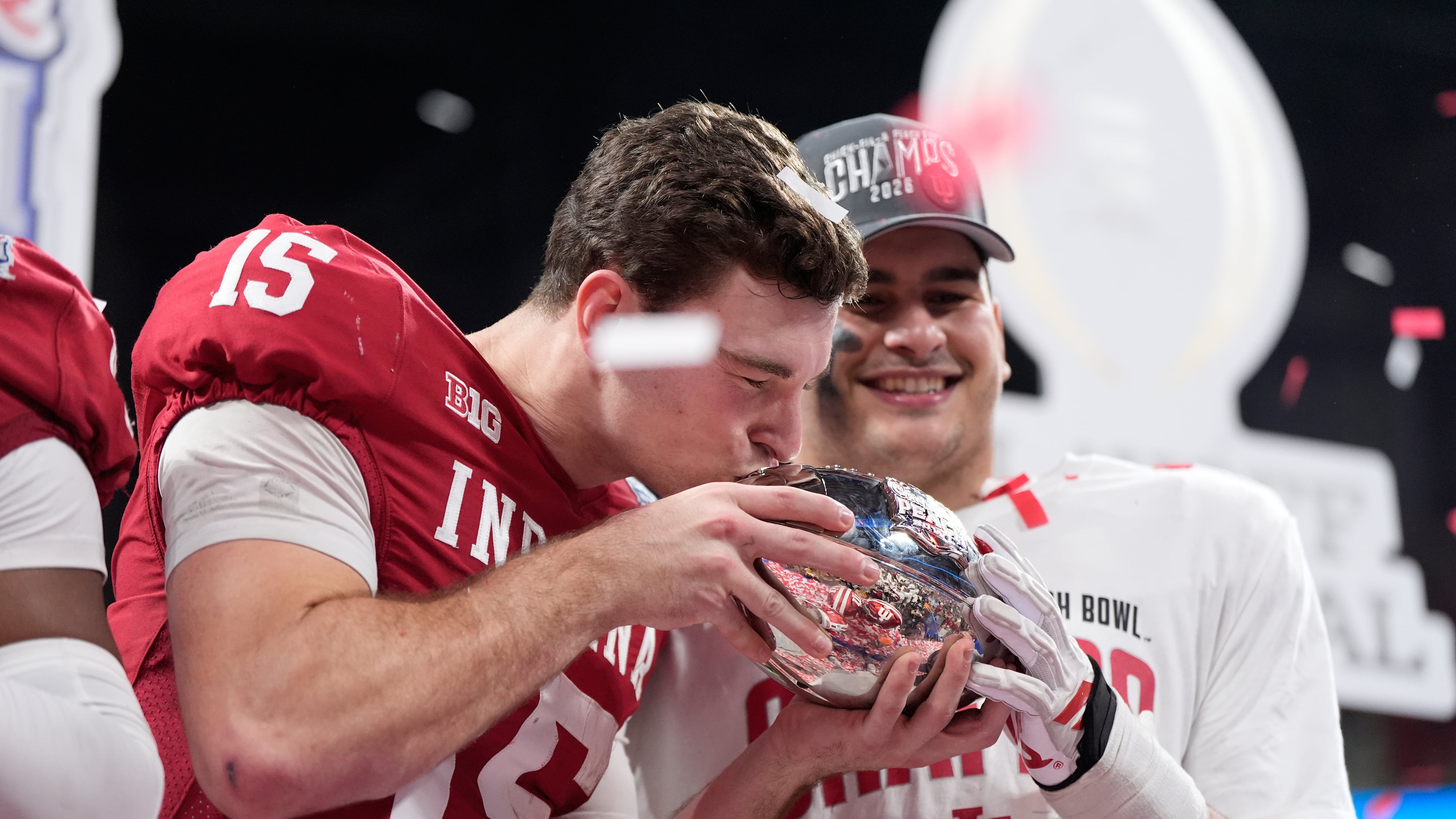 Indiana quarterback Fernando Mendoza (15) kisses the trophy after the Peach Bowl NCAA college football playoff semifinal against Oregon, Friday, Jan. 9, 2026, in Atlanta. (AP Photo/Brynn Anderson)