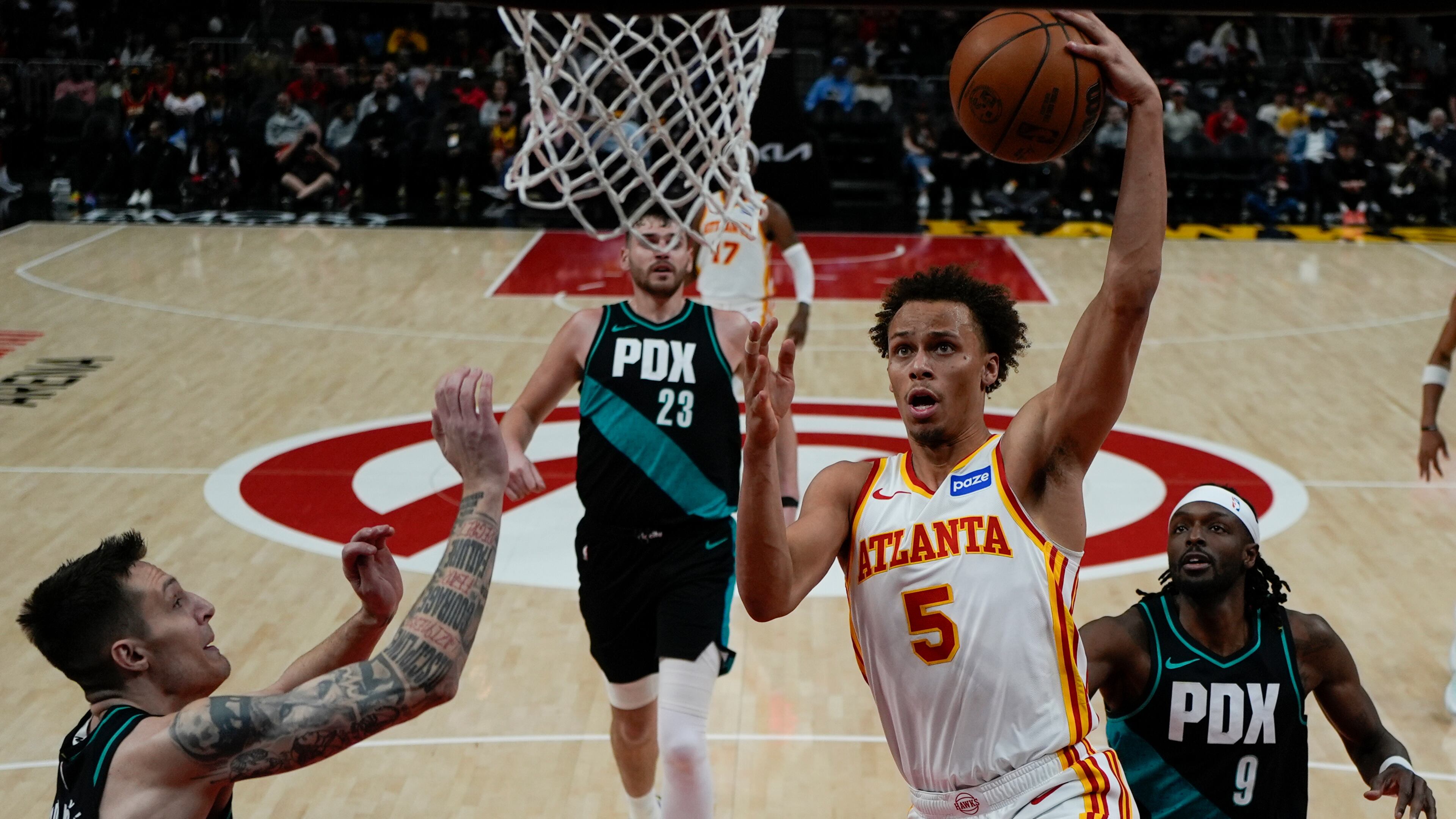 Atlanta Hawks guard Dyson Daniels (5) shoots against Portland Trail Blazers guard Vit Krejci (27) during the first half of an NBA basketball game, Sunday, March 1, 2026, in Atlanta. (AP Photo/Mike Stewart)
