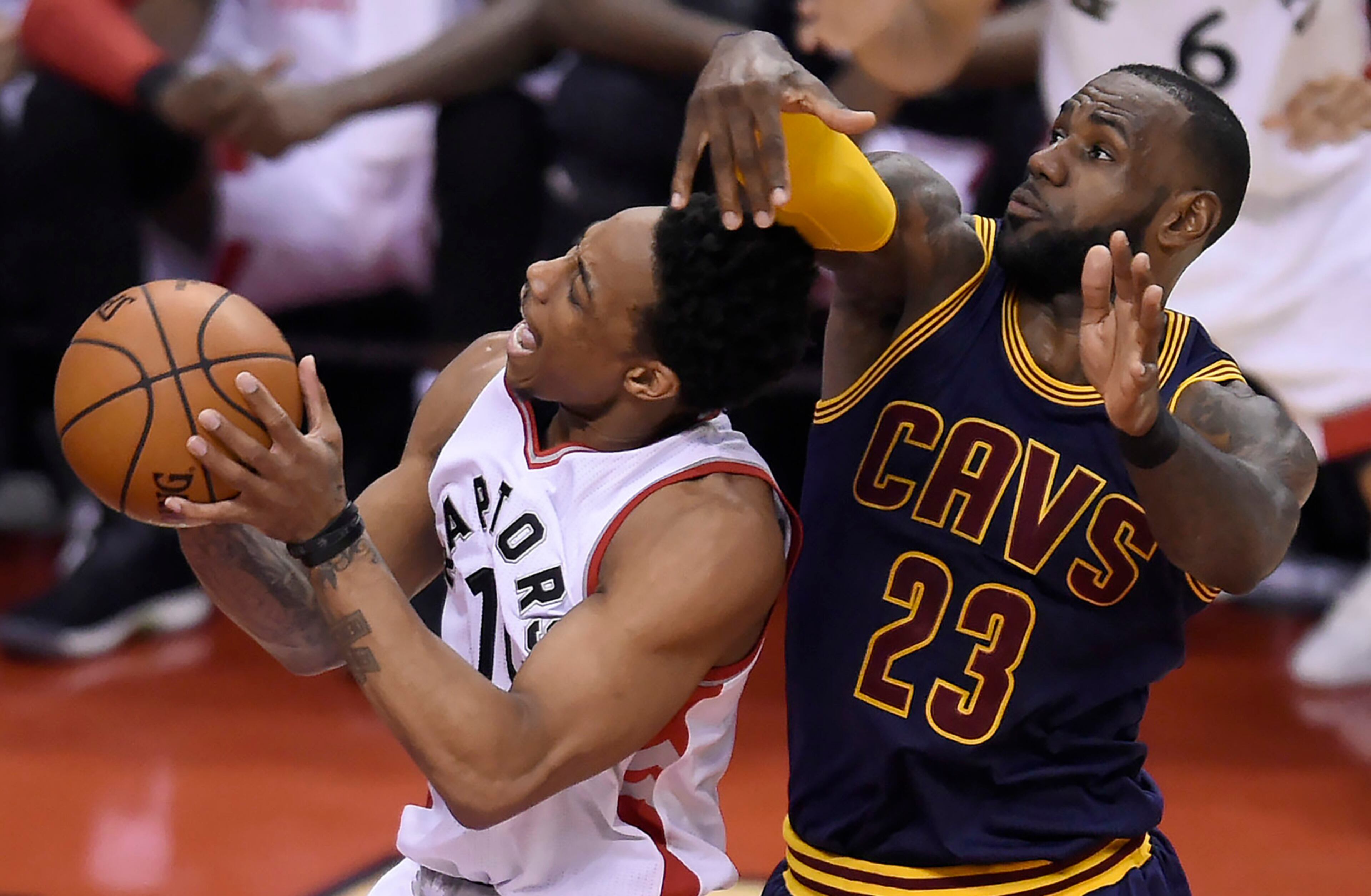 Cleveland Cavaliers forward LeBron James (23) fouls Toronto Raptors guard DeMar DeRozan (10) during the first half of Game 4 of a second-round NBA basketball playoff series in Toronto, Sunday, May 7, 2017. (Nathan Denette/The Canadian Press via AP)