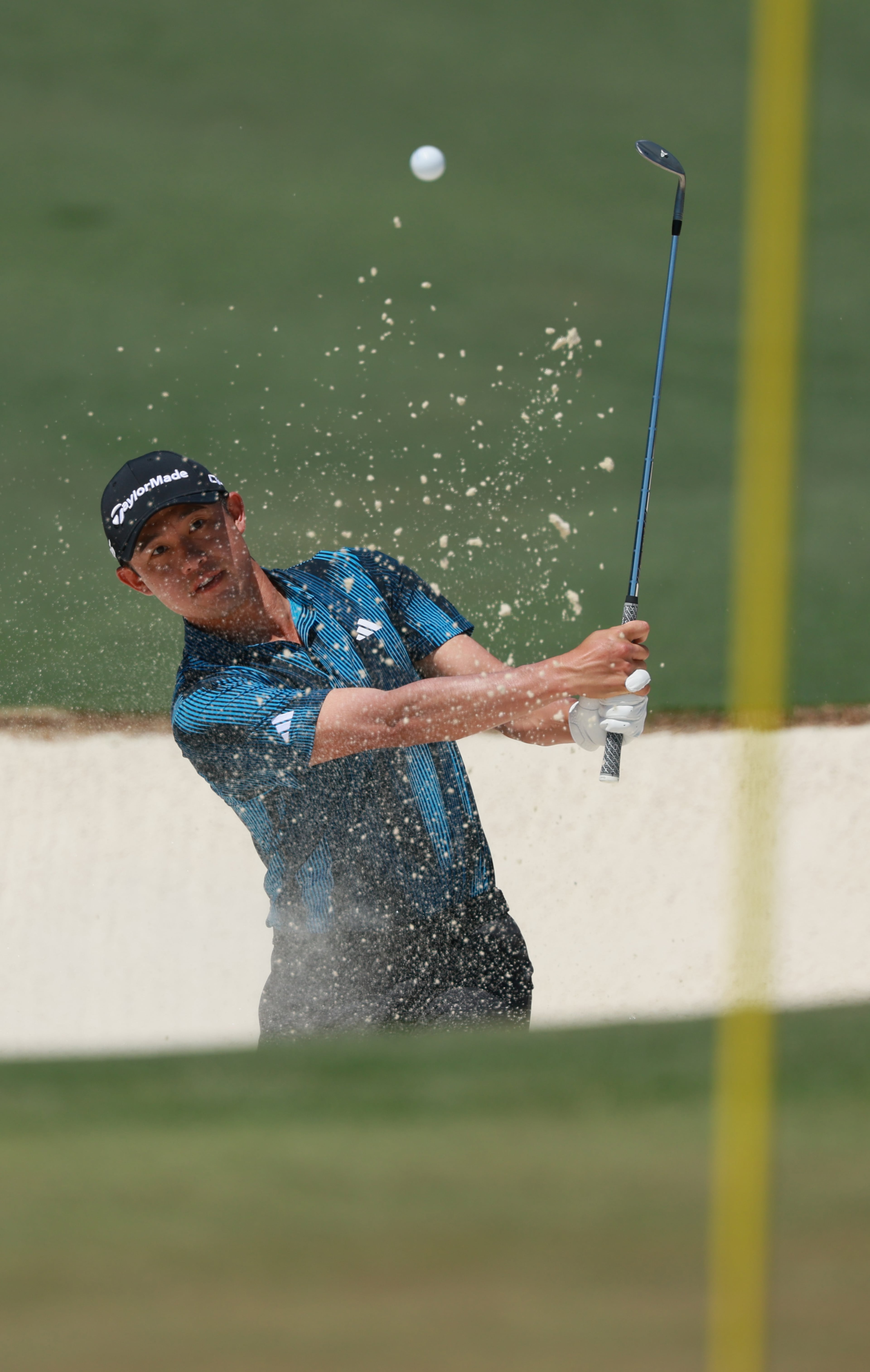 Collin Morikawa chips out of bunker onto second green during final round of the Masters, at Augusta National Golf Club, Sunday, April 12, 2026, in Augusta, GA (Jason Getz/AJC)