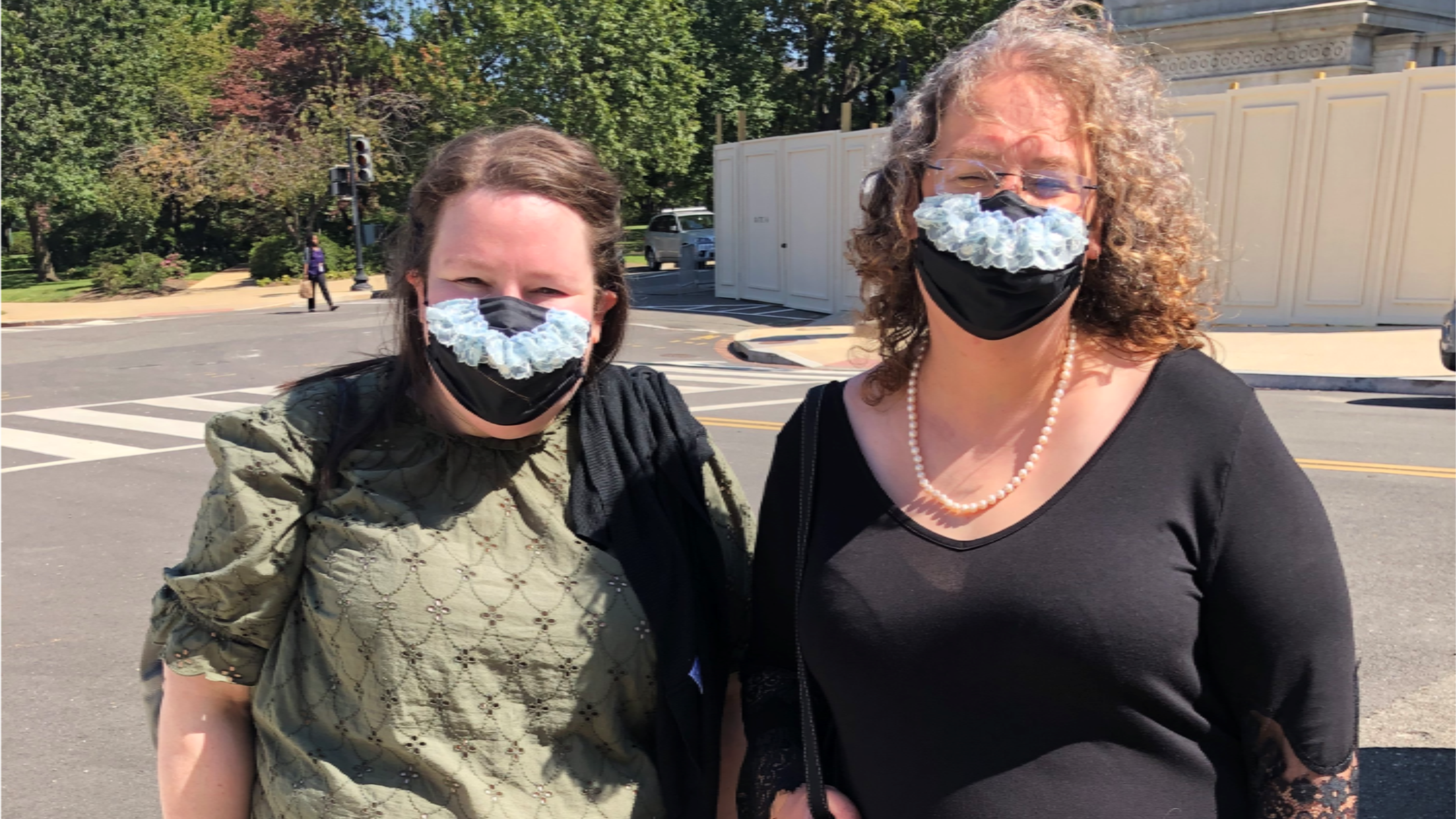 Bridget Miliacca, of Milwaukee, and Rhiannon Davis, of Hobart, Ind., drop to Washington in order to pay respects to Supreme Court Justice Ruth Bader Ginsburg on Wednesday, Sept. 23, 2020. A friend who makes masks added blue lace in order to mimic the collars Ginsburg often wore with her judicial robe. (Tia Mitchell/AJC)