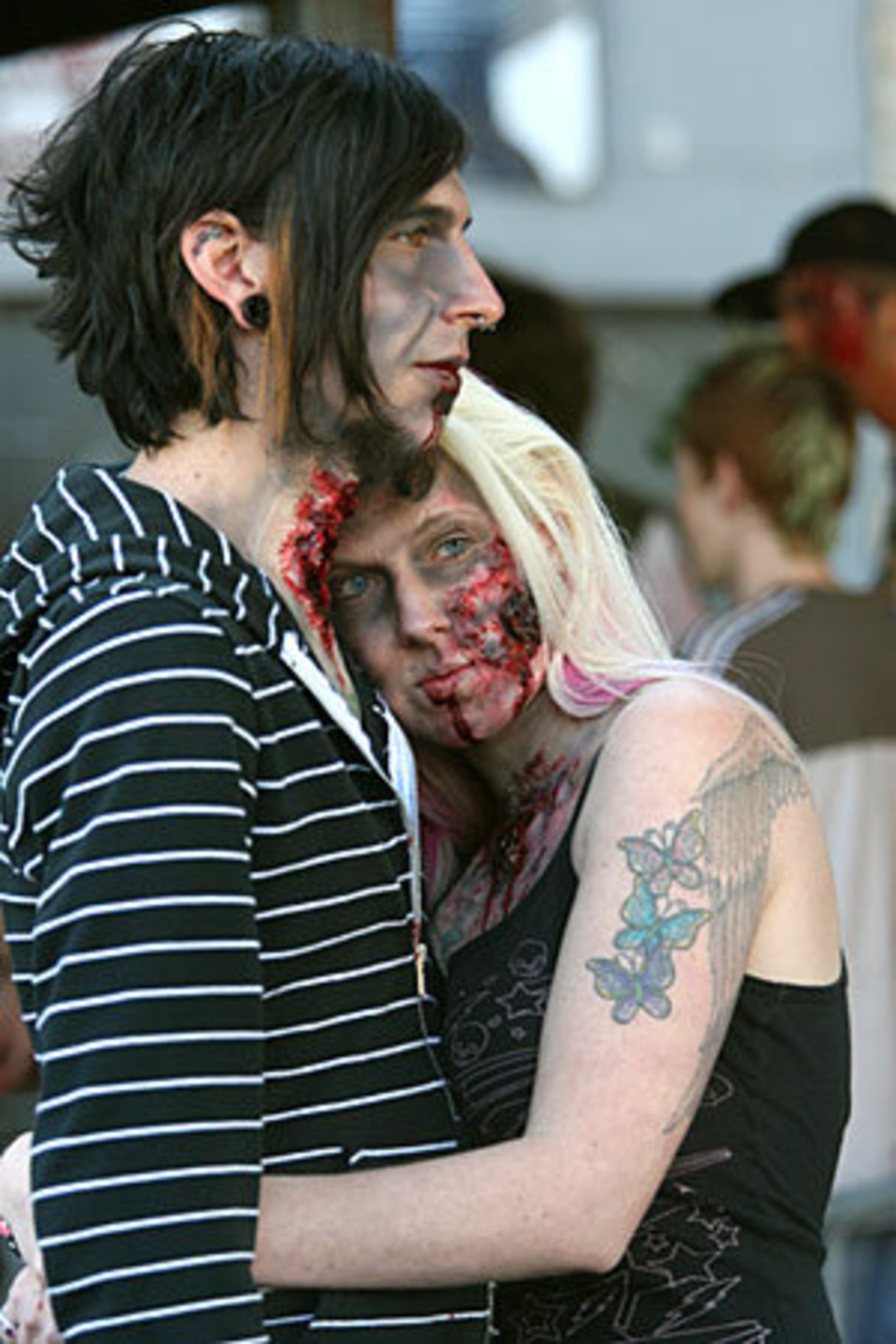 Sharing a little zombie love, Mike Tunno of Atlanta (left) and Christina Barter of Stockbridge snuggle before the start of the Zombie Walk.