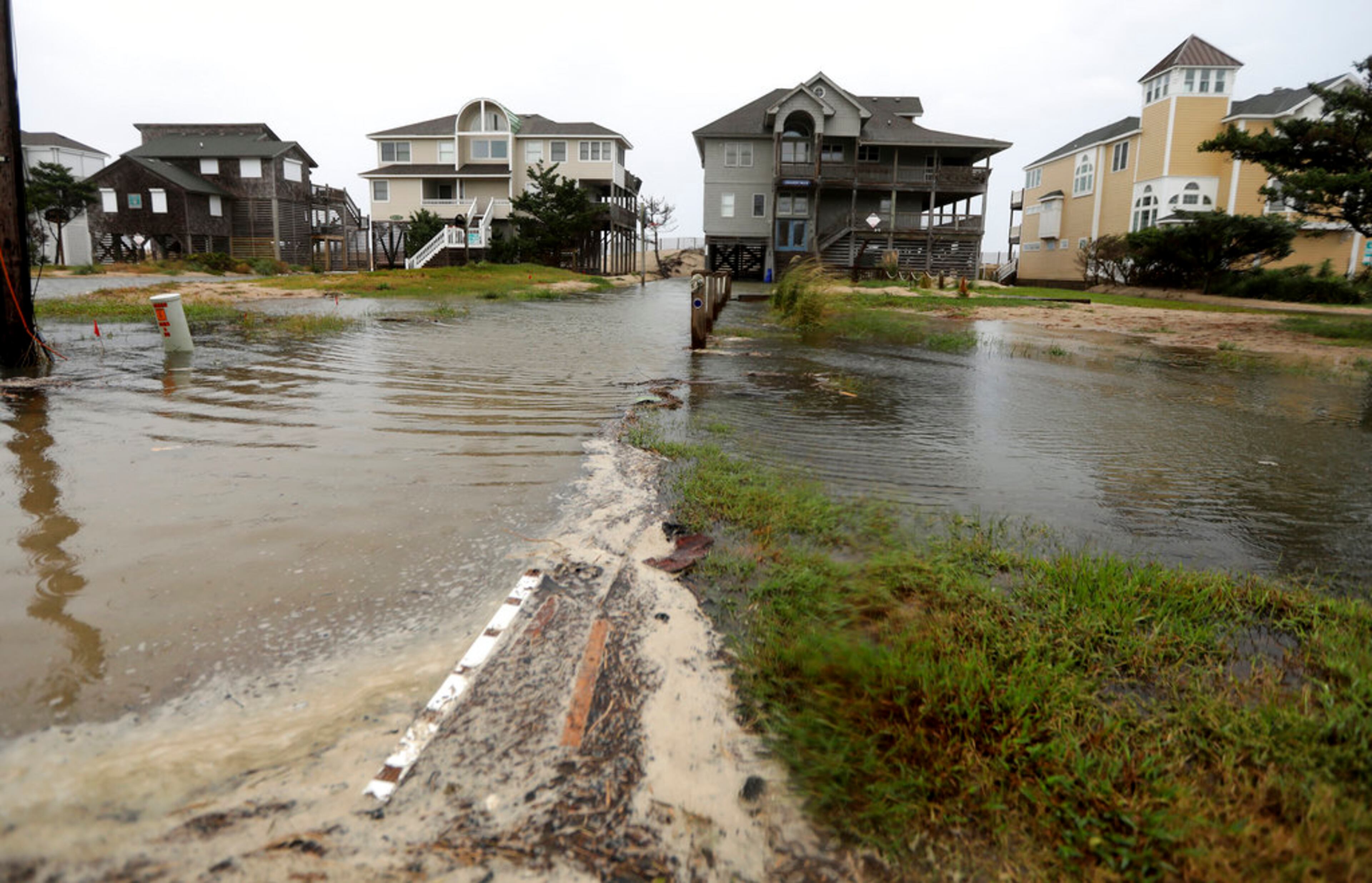 Ocean water breeches to the dunes in Avon, N.C., as the first effects of Hurricane Florence reach Hatteras Island on Thursday, Sept. 13, 2018. (Steve Earley/The Virginian-Pilot via AP)