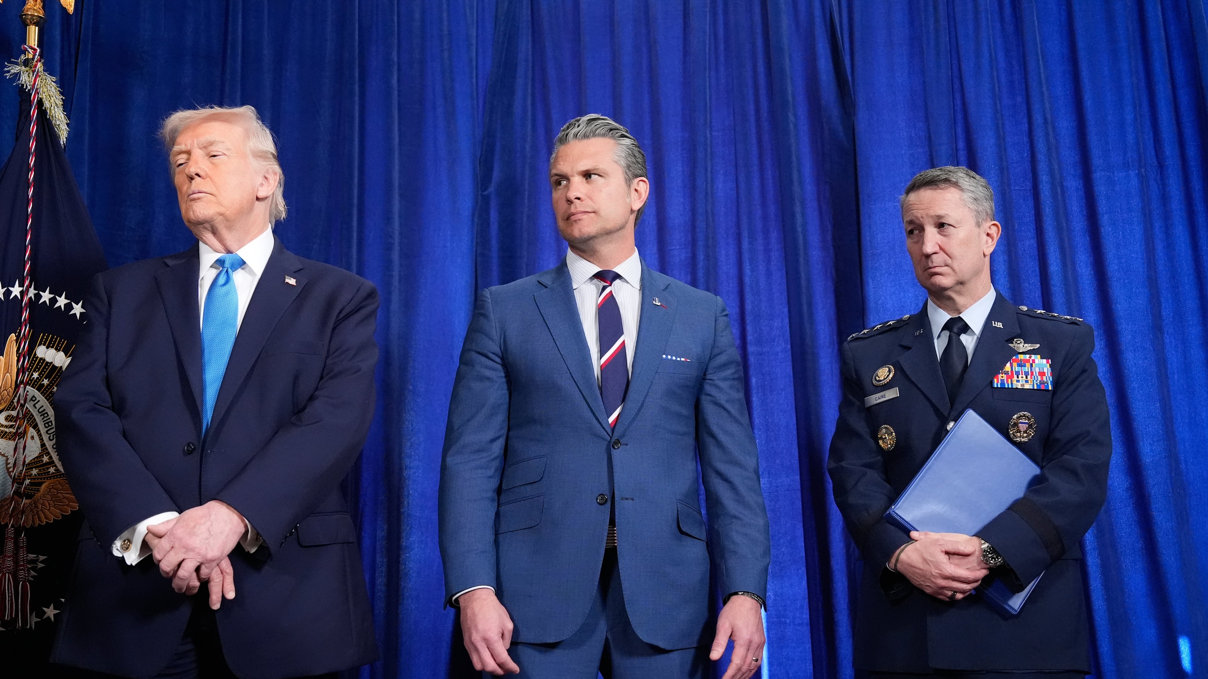 President Donald Trump, Defense Secretary Pete Hegseth and Chairman of the Joint Chiefs of Staff Gen. Dan Caine listen as Secretary of State Marco Rubio speaks during a news conference at Mar-a-Lago, Saturday, Jan. 3, 2026, in Palm Beach, Fla. (AP Photo/Alex Brandon)