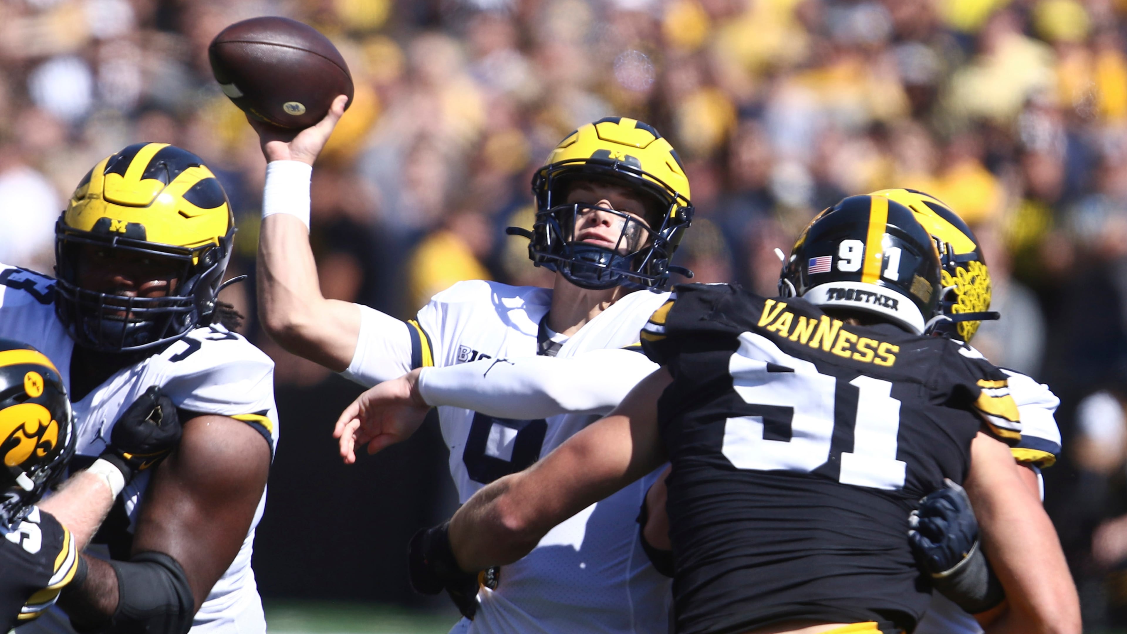 Michigan quarterback J.J. McCarthy throws the ball under pressure from Iowa defensive lineman Lukas Van Ness last season. (Matthew Holst/TNS)