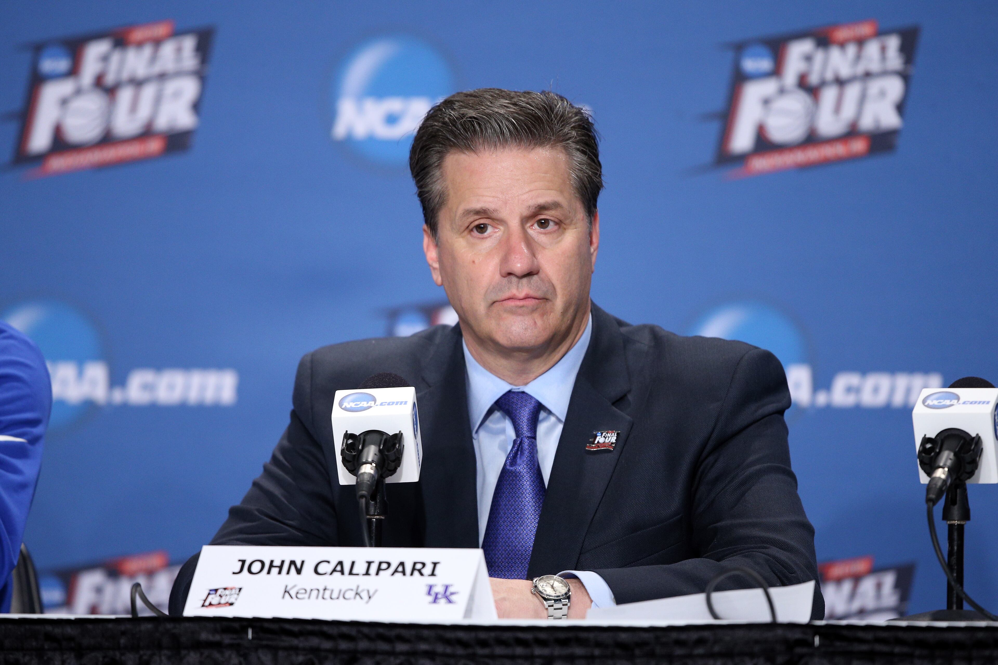 INDIANAPOLIS, IN - APRIL 04: Head coach John Calipari of the Kentucky Wildcats looks on in the post game press conference after being defeated by the Wisconsin Badgers during the NCAA Men's Final Four Semifinal at Lucas Oil Stadium on April 4, 2015 in Indianapolis, Indiana. Wisconsin defeated Kentucky 71-64. (Photo by Joe Robbins/Getty Images)