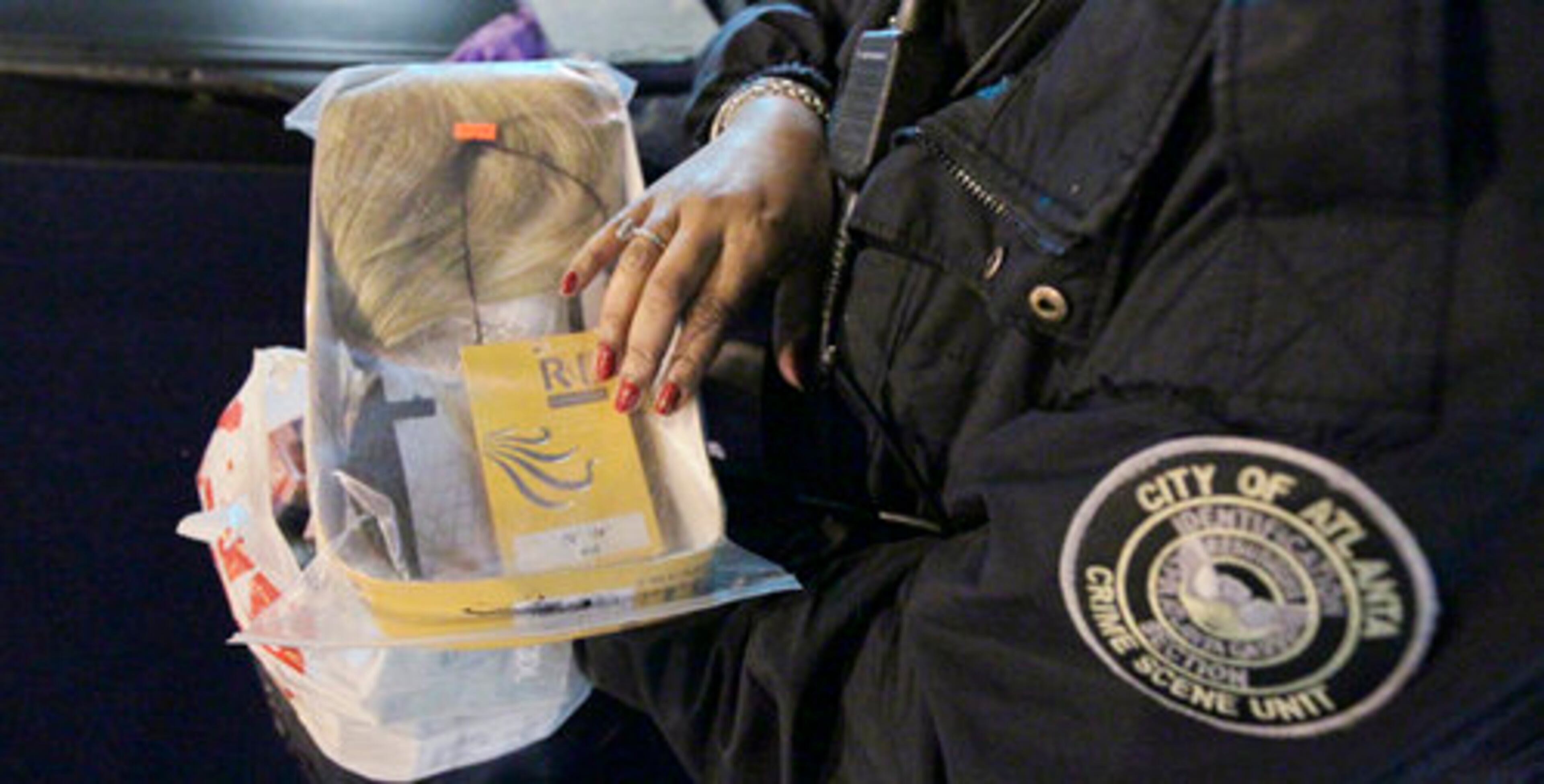 APD crime scene investigation technician Pebbles Felder bags evidence.