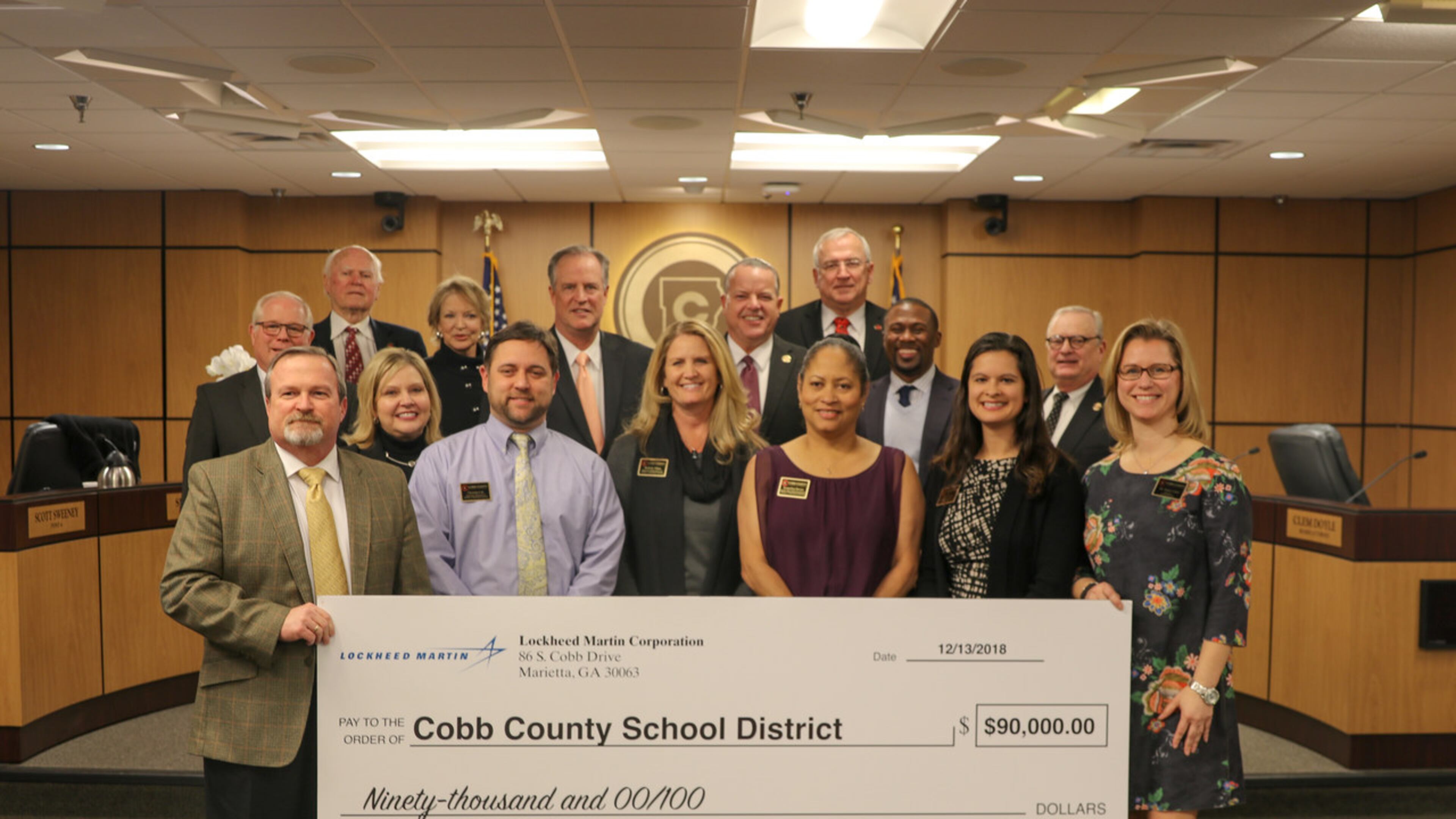 Lockheed Martin Corp. officials presented a $90,000 check for use in science, technology, engineering and math education to the Cobb County Board of Education and Cobb County School District Superintendent Chris Ragsdale during their Dec. 13 meeting. (Courtesy of the Cobb County School District)
