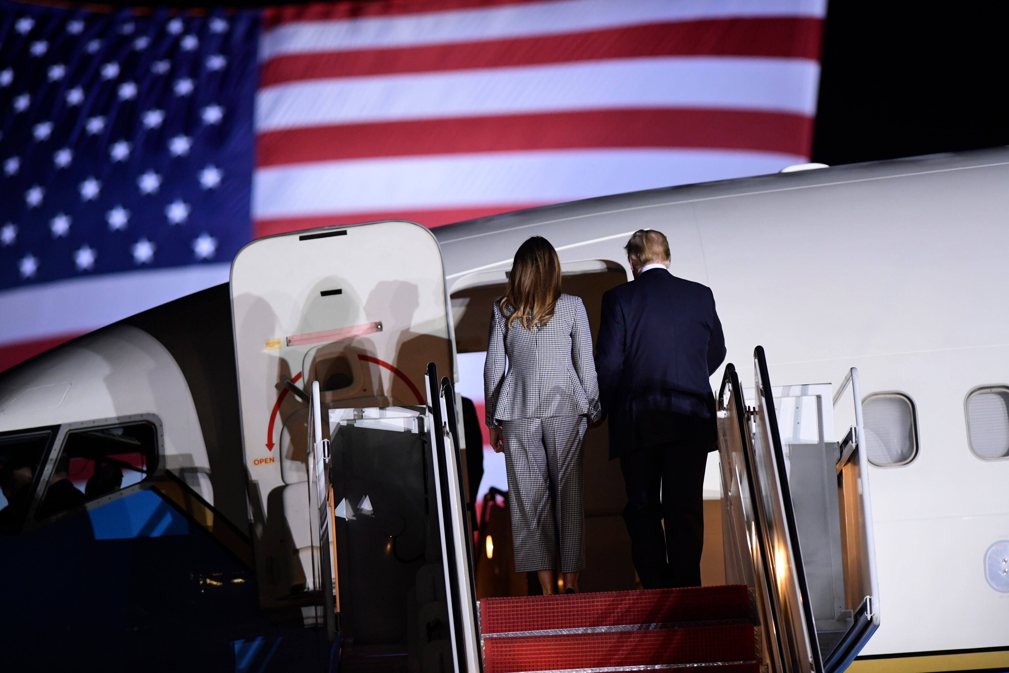 President Donald Trump and first lady Melania Trump stand on the steps of a U.S. military plane carrying three Americans freed from captivity in North Korea, to greet them upon their arrival at Andrews Air Force Base in Md., Thursday, May 10, 2018. (AP Photo/Susan Walsh)