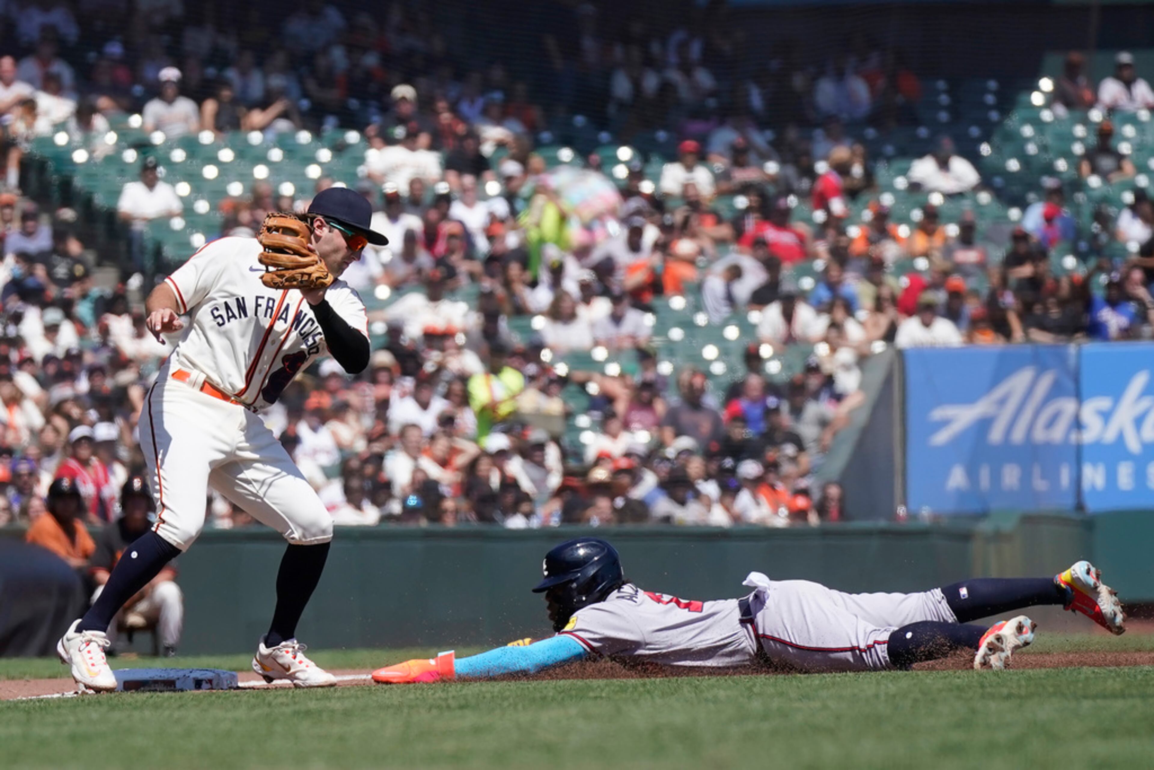 Atlanta Braves' Ronald Acuna Jr., right, steals third base next to San Francisco Giants third baseman Casey Schmitt during the third inning of a baseball game in San Francisco, Saturday, Aug. 26, 2023. (AP Photo/Jeff Chiu)