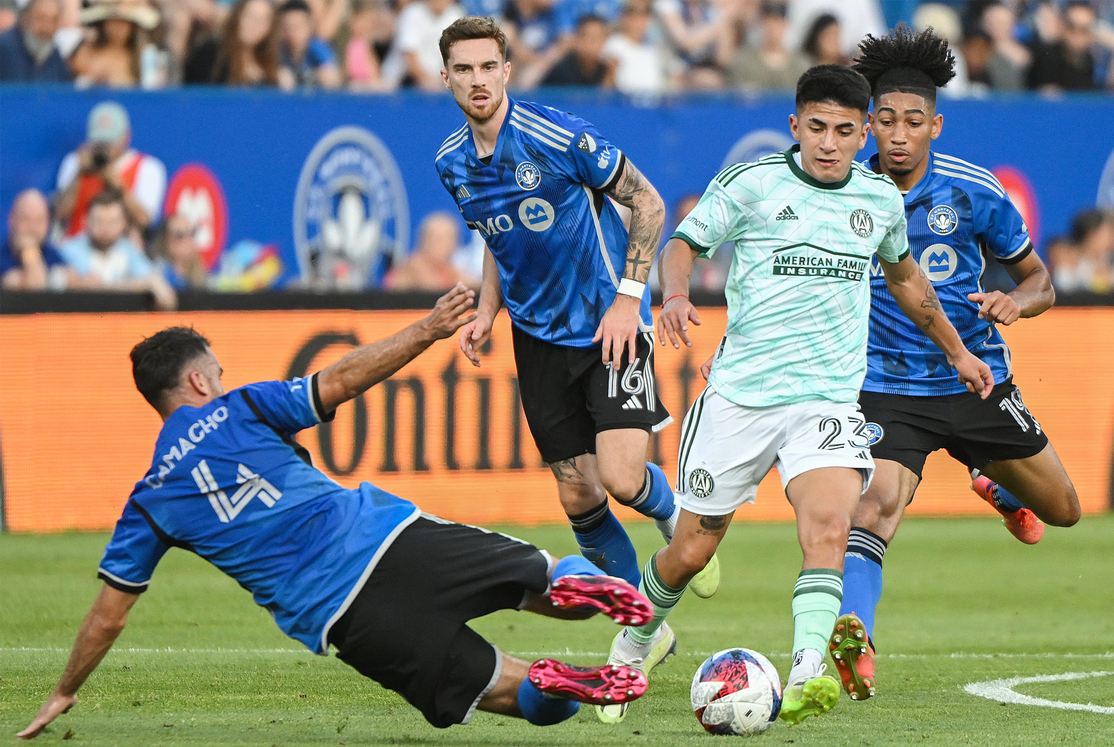 CF Montreal's Rudy Camacho (4) challenges Atlanta United's Thiago Almada (23) during the first half of an MLS soccer match Saturday, July 8, 2023, in Vancouver, British Columbia. (Graham Hughes/The Canadian Press via AP)