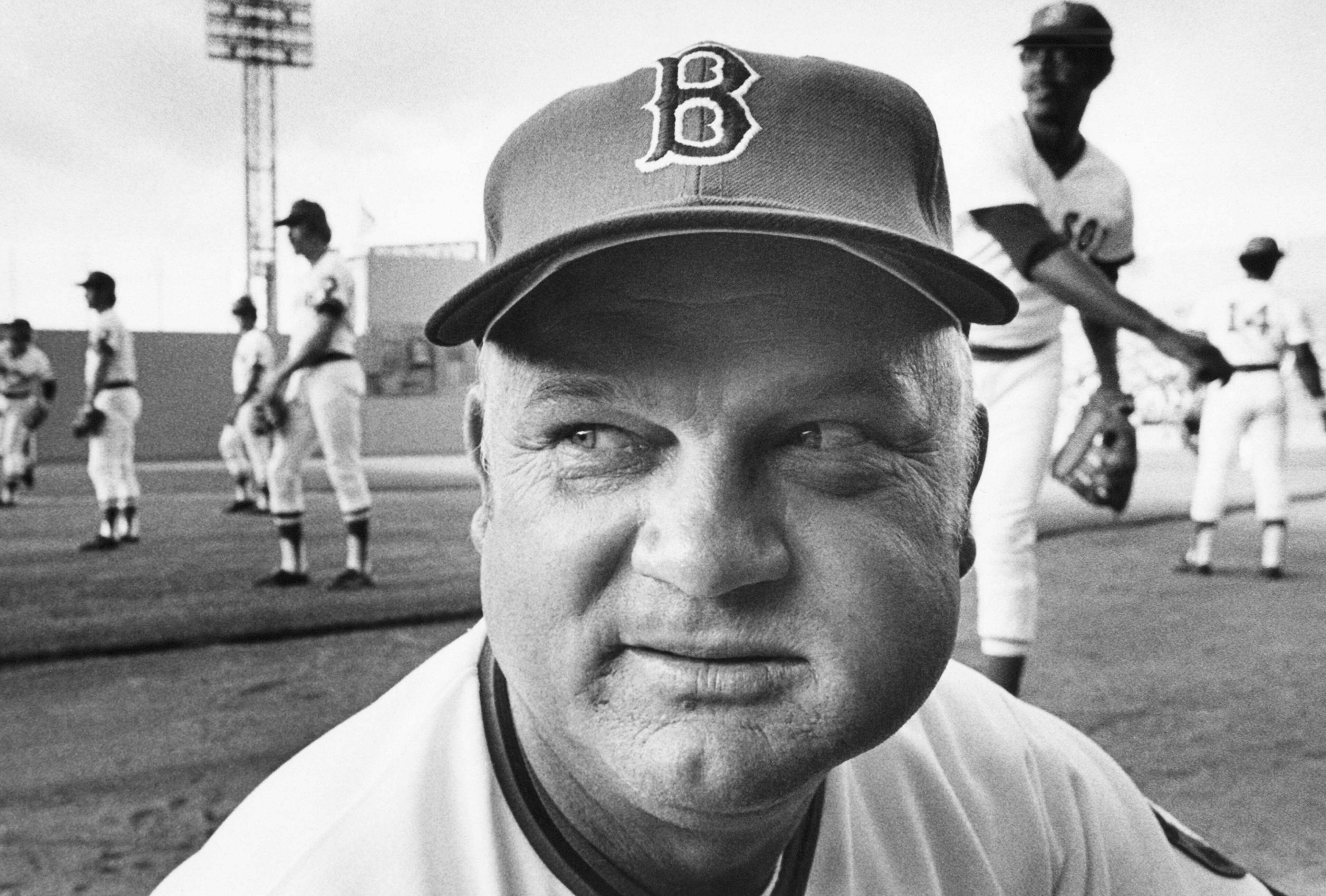 In this July 26, 1976, file photo, Boston Red Sox manager Don Zimmer, his left cheek ballooned out with chewing tobacco, scans the home crowd at Fenway Park, prior to Boston's game with the Cleveland Indians, Zimmer's first home game as the baseball team's new skipper. Zimmer, a popular fixture in professional baseball for 66 years as a manager, player, coach and executive, has died. He was 83. Zimmer was still working for the Tampa Bay Rays as a senior adviser. The team confirmed Wednesday night, June 4, 2014, that he had died. Zimmer had been in a rehabilitation center in Florida since having heart surgery in mid-April. (AP Photo/File)