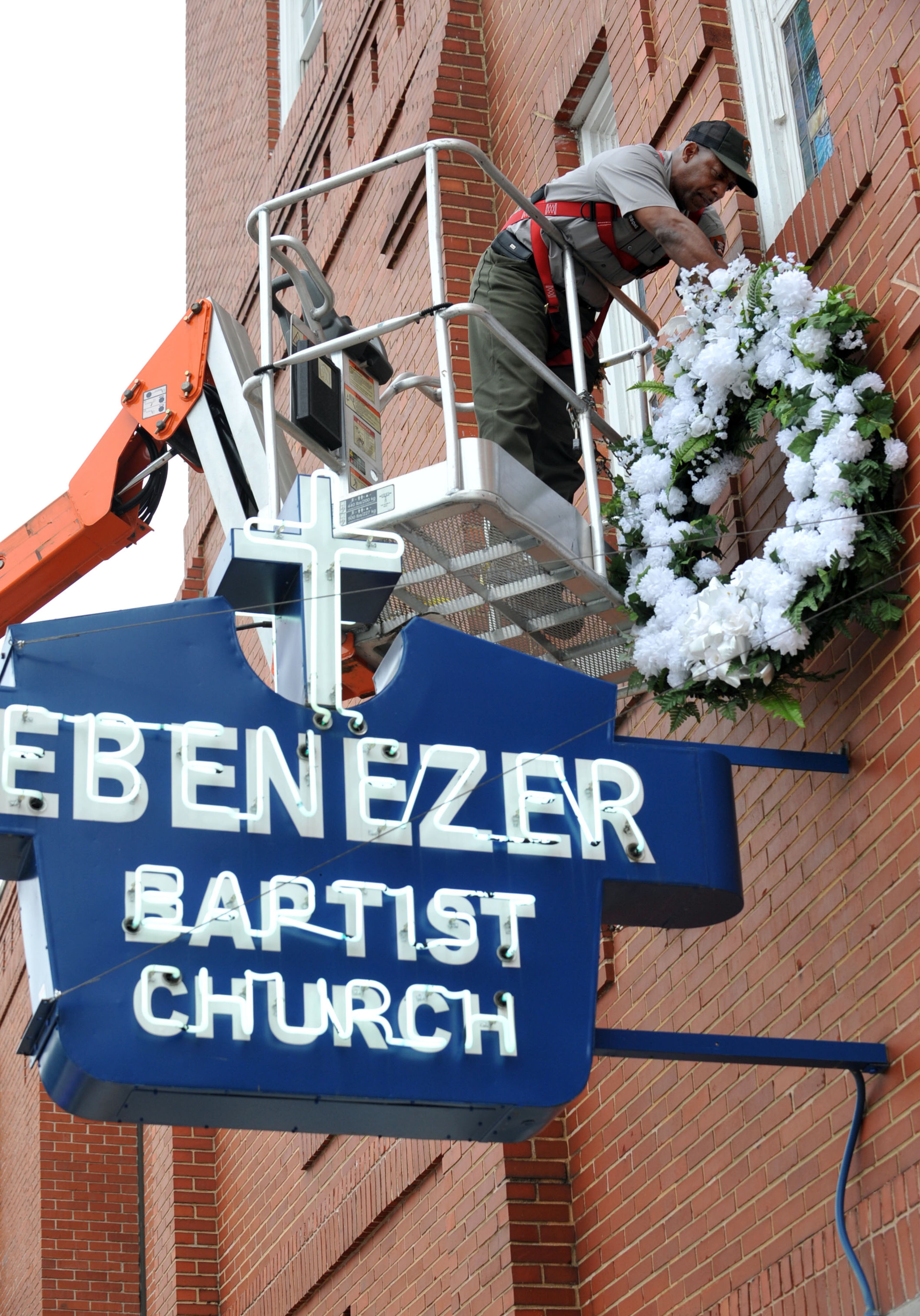A National Park Service worker installed the wreath on the front of Ebenezer Baptist Church on the 46th anniversary of King's assassination on April 4, 2014. (Kent Johnson)