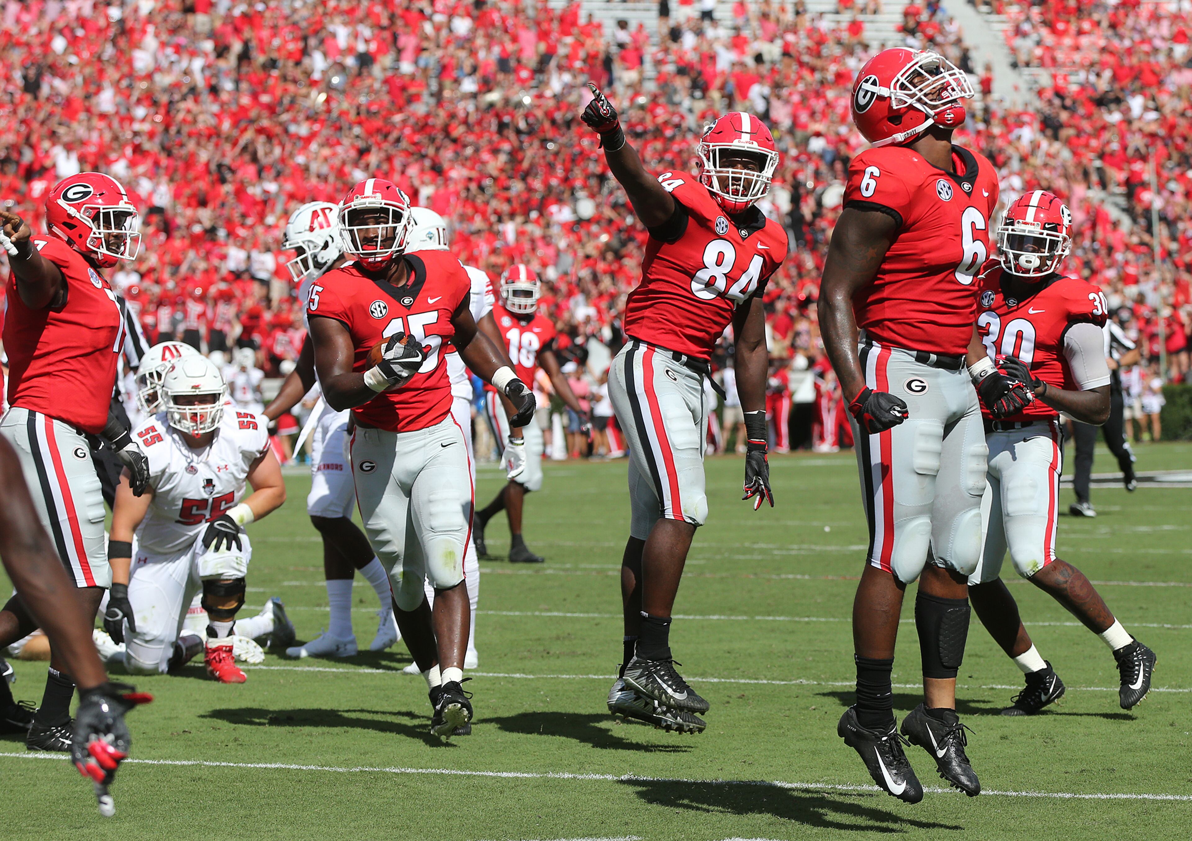 September 1, 2018 Athens: Georgia Bulldogs players celebrate as DâAndre Walker (left) comes up with a fumble recovery against Austin Peay during the first half in a NCAA college football game on Saturday, Sept 1, 2018, in Athens. Curtis Compton/ccompton@ajc.com