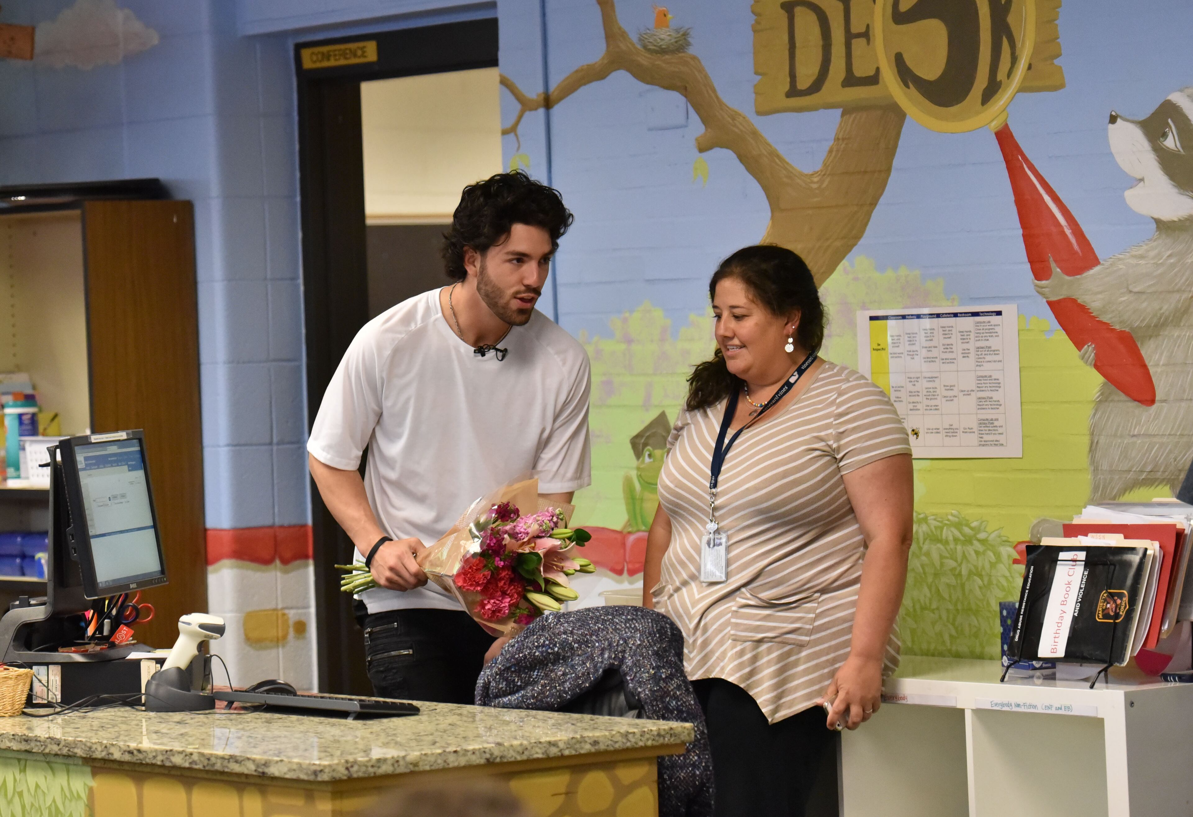 Dansby Swanson holds a bouquet of flowers to surprise his mother Nancy at West Side Elementary School in Marietta on Tuesday, May 2, 2017.
