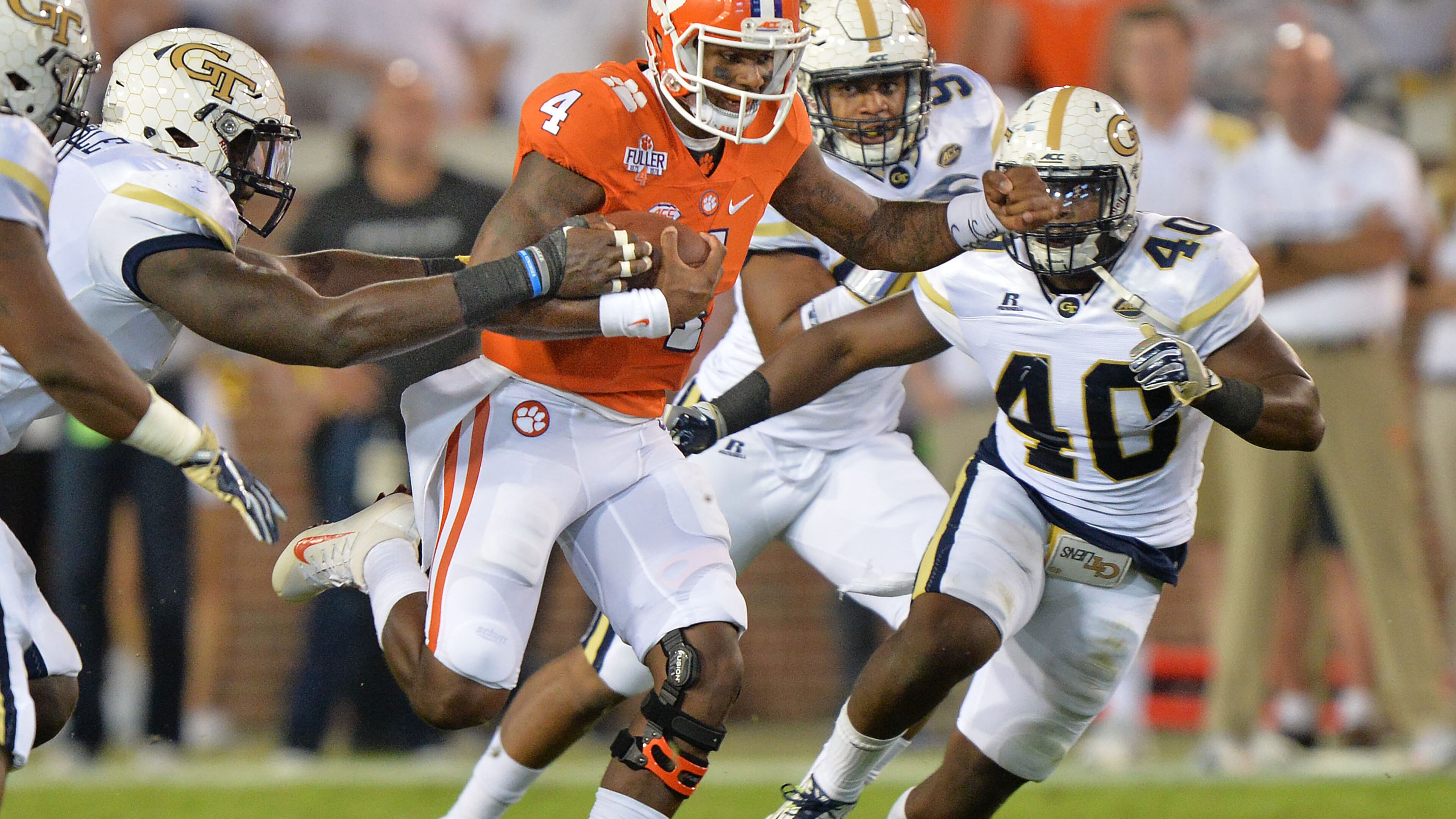 September 22, 2016 Atlanta - Clemson Tigers quarterback Deshaun Watson (4) carries a ball as Georgia Tech Yellow Jackets defensive lineman Patrick Gamble (left) tries to steal in the first half at Bobby Dodd Stadium on Thursday, September 22, 2016. HYOSUB SHIN / HSHIN@AJC.COM