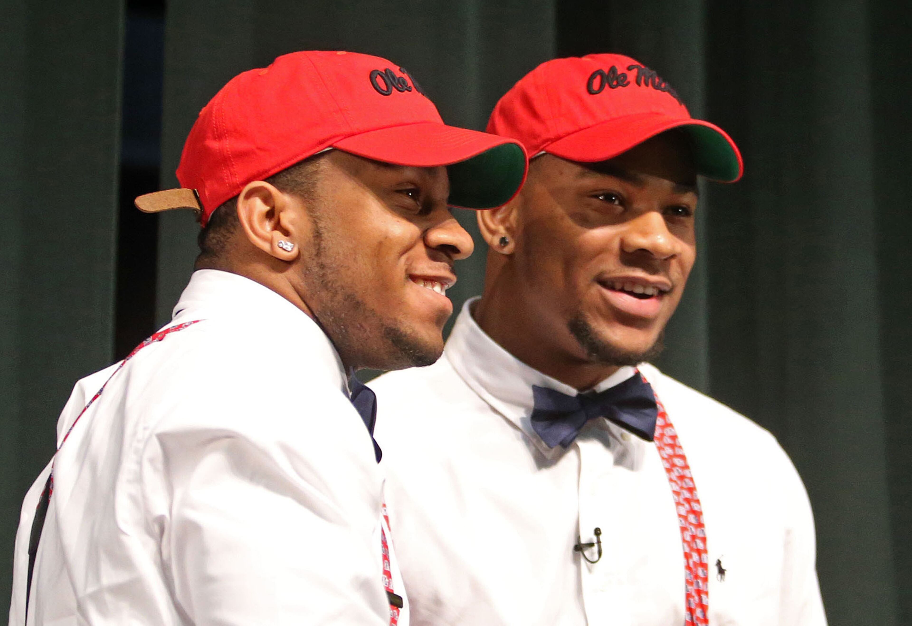Brothers Denzel Nkemdiche, left, and Robert Nkemdiche celebrate after Robert made his announcement to attend Ole Miss on national signing day at Grayson High School.