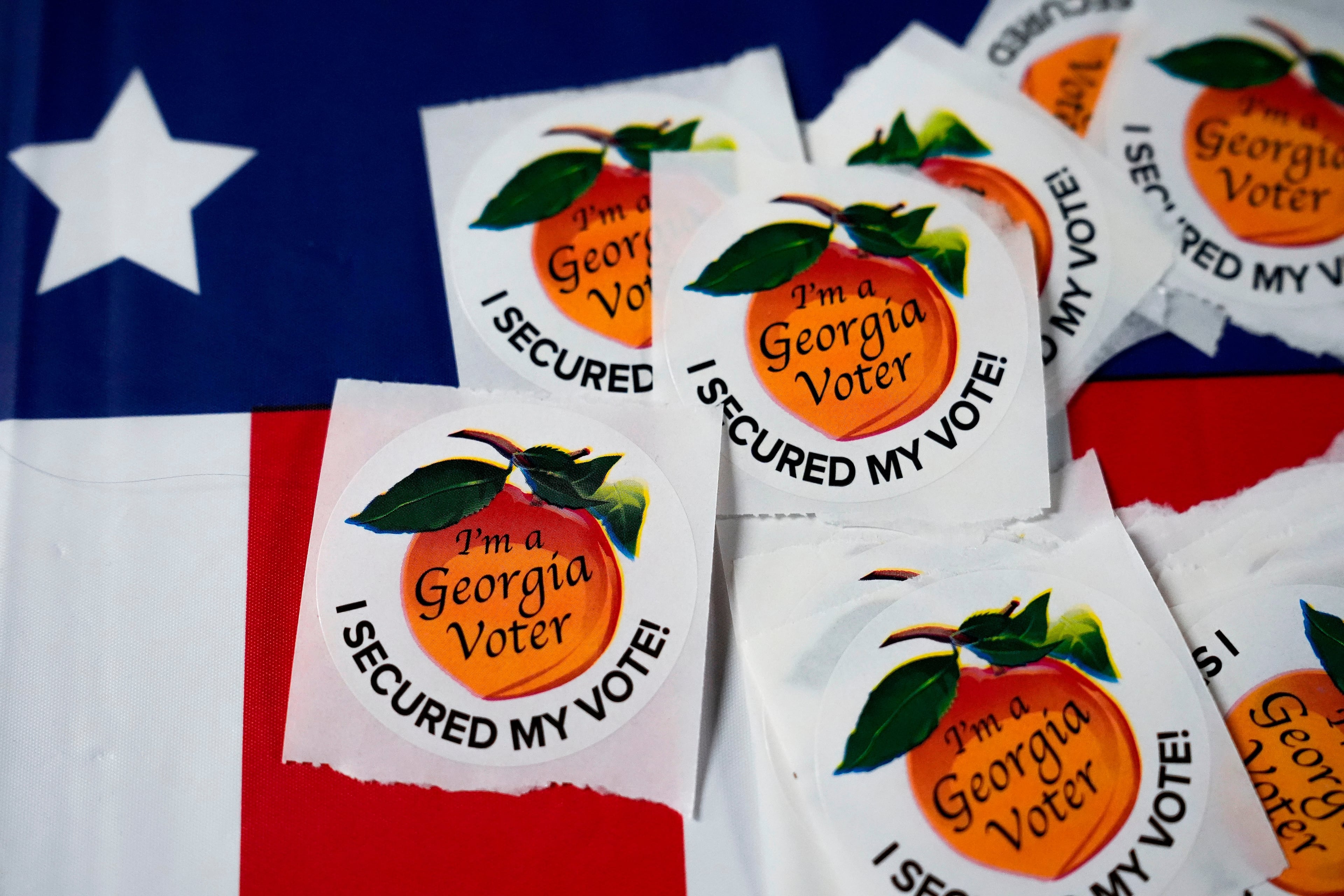 Stickers sit on a table inside an Atlanta polling place in 2024. (Brynn Anderson/AP)
