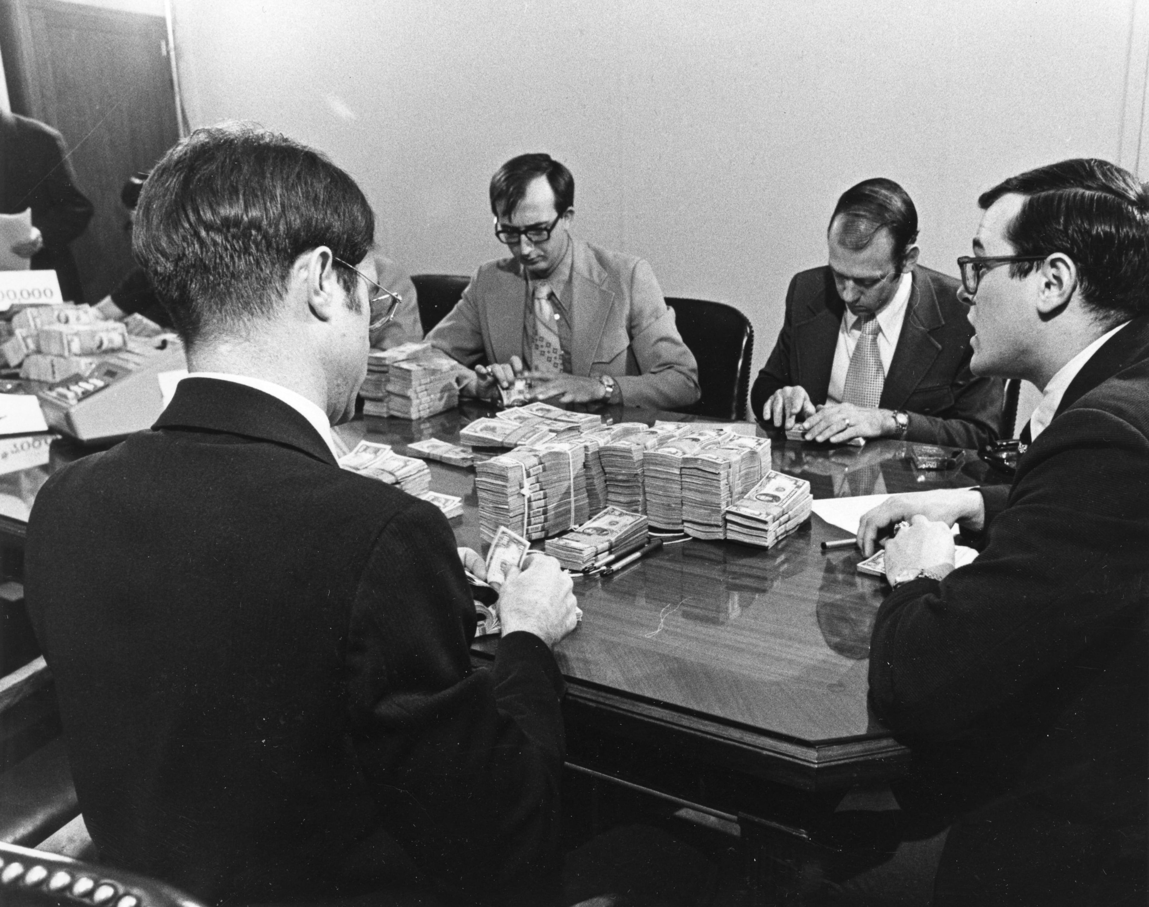 Men counting $700,000 of ransom money for Atlanta Journal Constitution editor Reg Murphy, Atlanta, Georgia, February 23, 1974. Murphy's captor instructed him to make a tape that explained his kidnappers' intentions. He was instructed to say that his kidnappers were an organized militia who intended to conduct guerrilla warfare and wanted $700,000 in case to help fund their cause.(Bud Skinner)