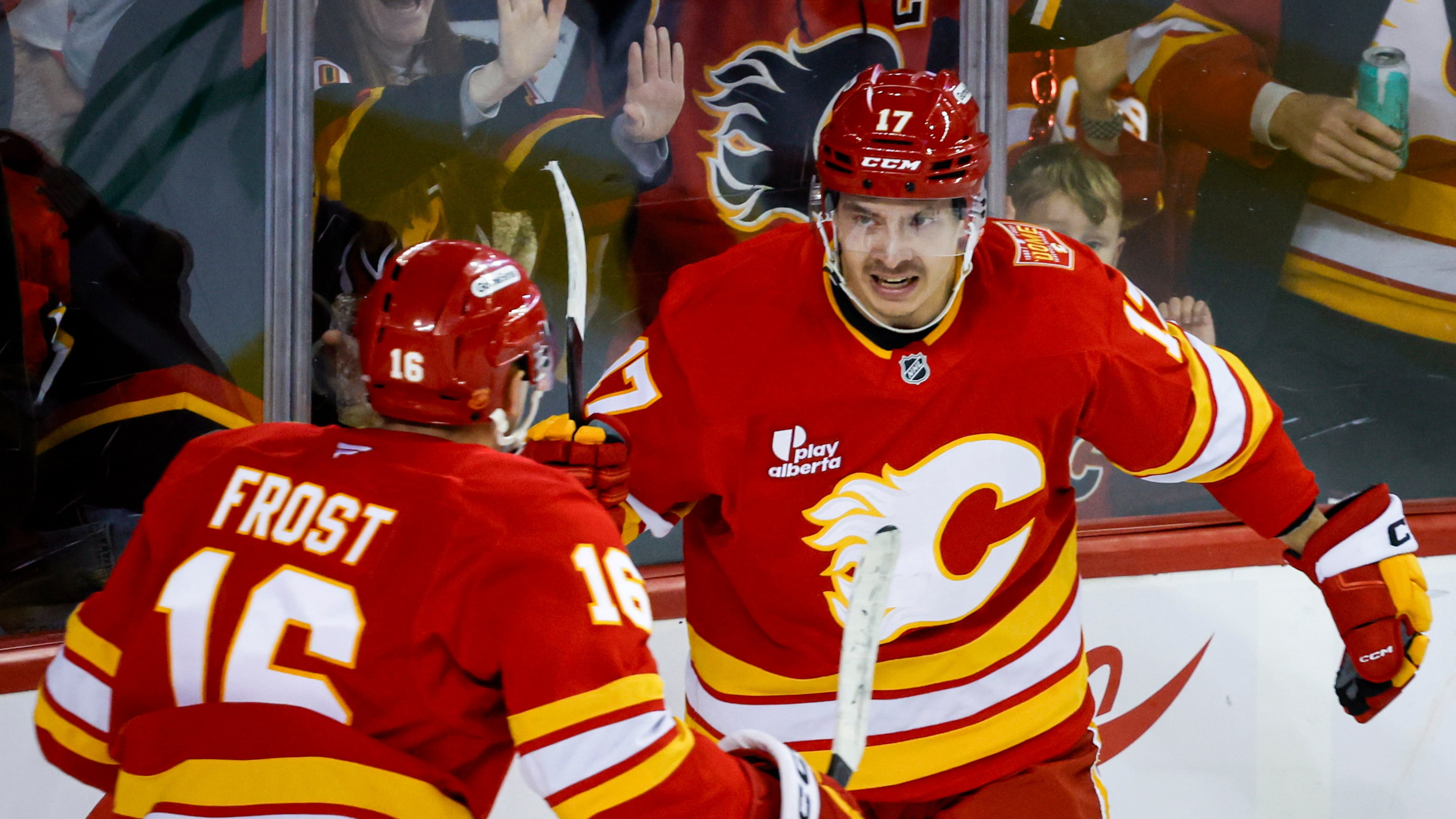 Calgary Flames' Yegor Sharangovich, right, celebrates his goal with teammate Morgan Frost during the third period of an NHL hockey game against the Carolina Hurricanes in Calgary, Alberta, Sunday, Oct. 18, 2026. (Jeff McIntosh/The Canadian Press via AP)