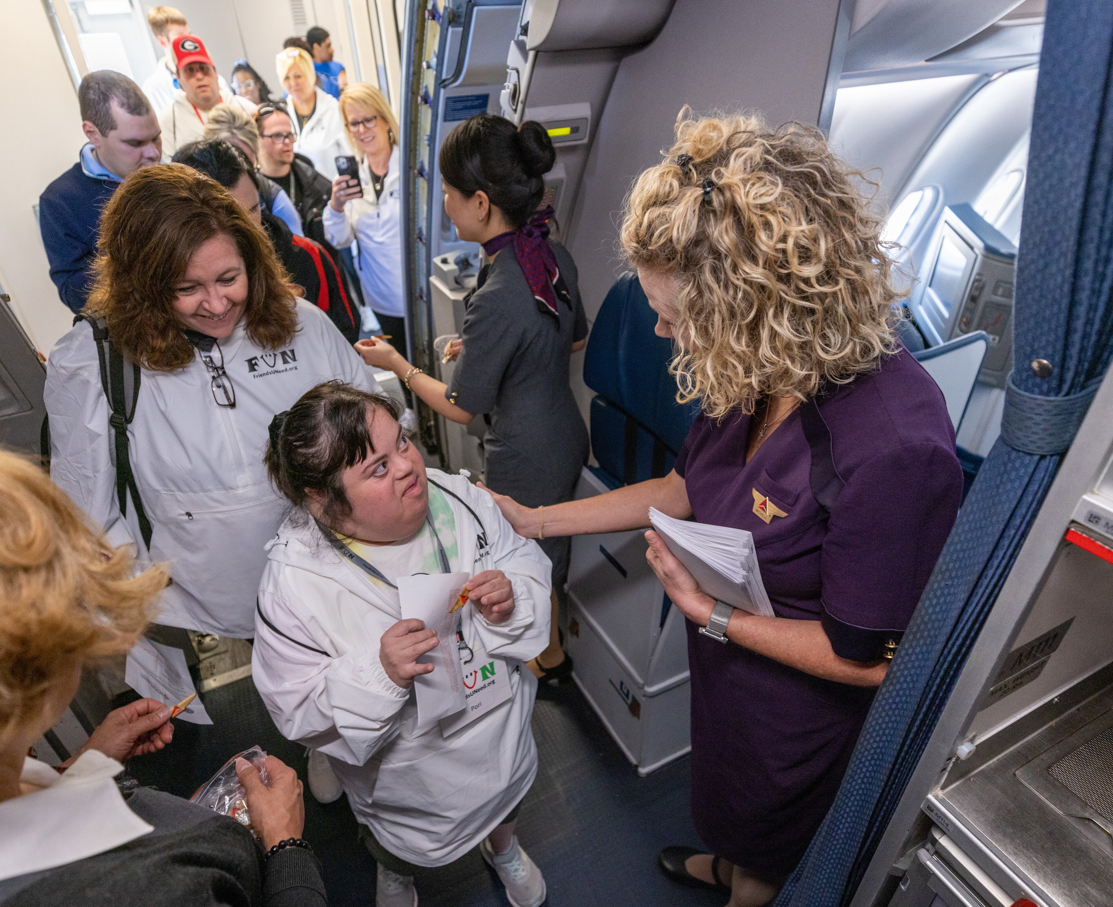 Pori Sheibani (Center) walks onto a Delta Air Lines plane during A Wings For All event at the Hartsfield-Jackson Atlanta International Airport Tuesday, April 11, 2023 (Steve Schaefer/steve.schaefer@ajc.com)