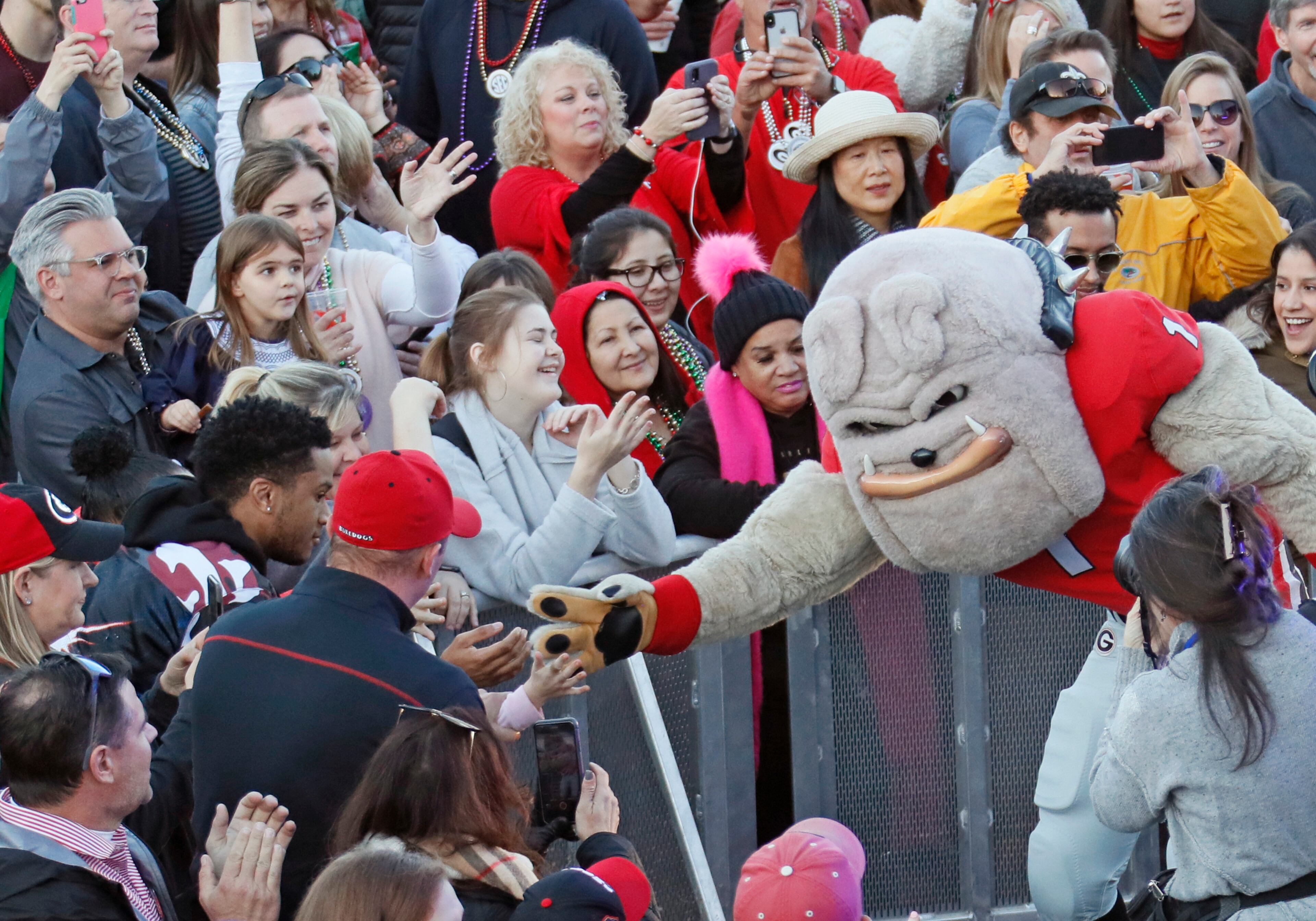 UGA mascot Hairy Dawg greets fans as the Georgia rally gets underway at the Sugar Bowl Tuesday. A Georgia Pep Rally followed one for Baylor at the Allstate Fan Fest in New Orleans. Bob Andres bandres@ajc.com