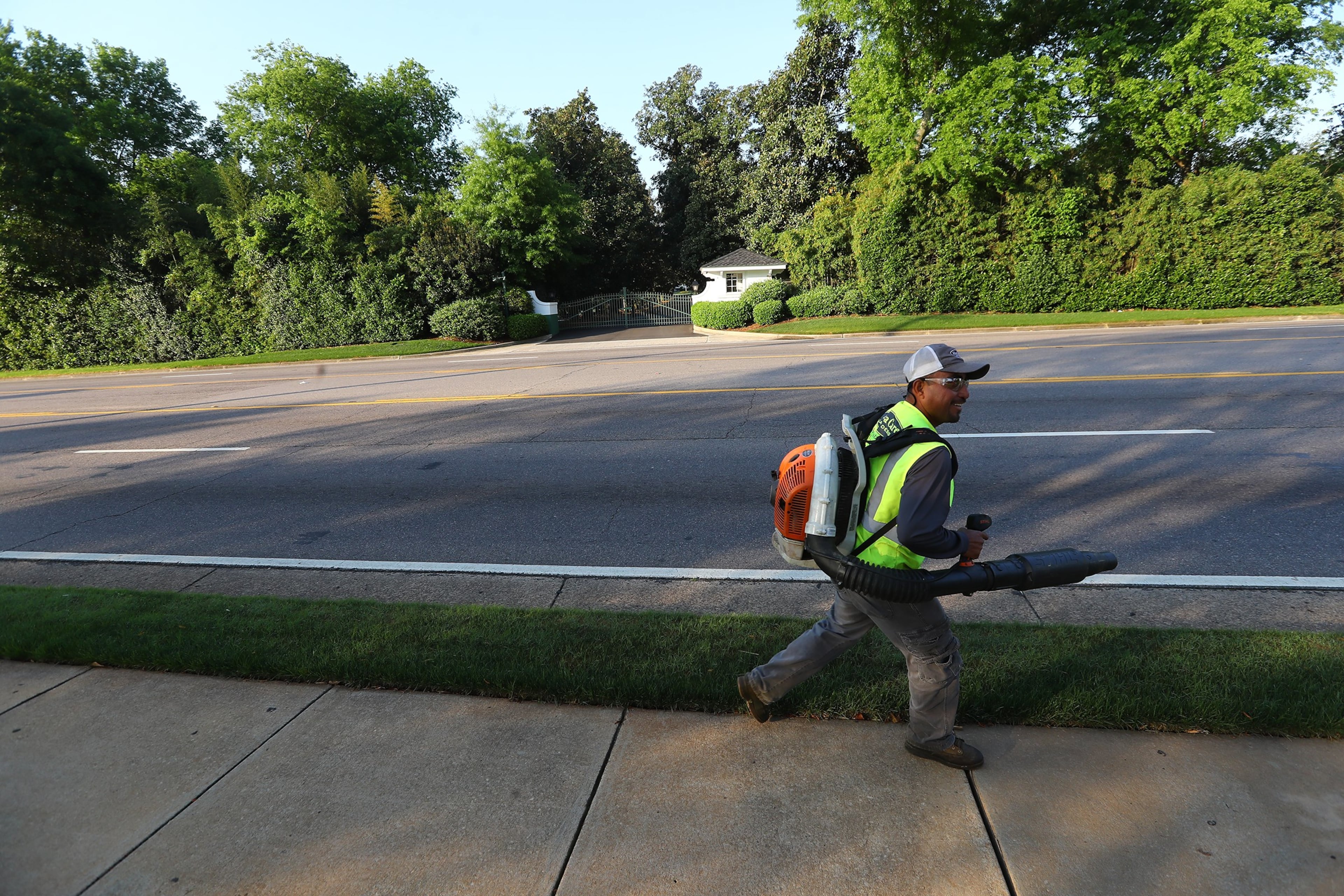 April 6, 2020 Augusta: A grounds keeper works across the street from the main gate to Augusta National Golf Club on what would have been the first practice round for the Masters on Monday, April 6, 2020, in Augusta. In collaboration with the leading organizations in golf, Augusta National Golf Club has identified November 9-15 as the intended dates to host the 2020 Masters. Curtis Compton ccompton@ajc.com