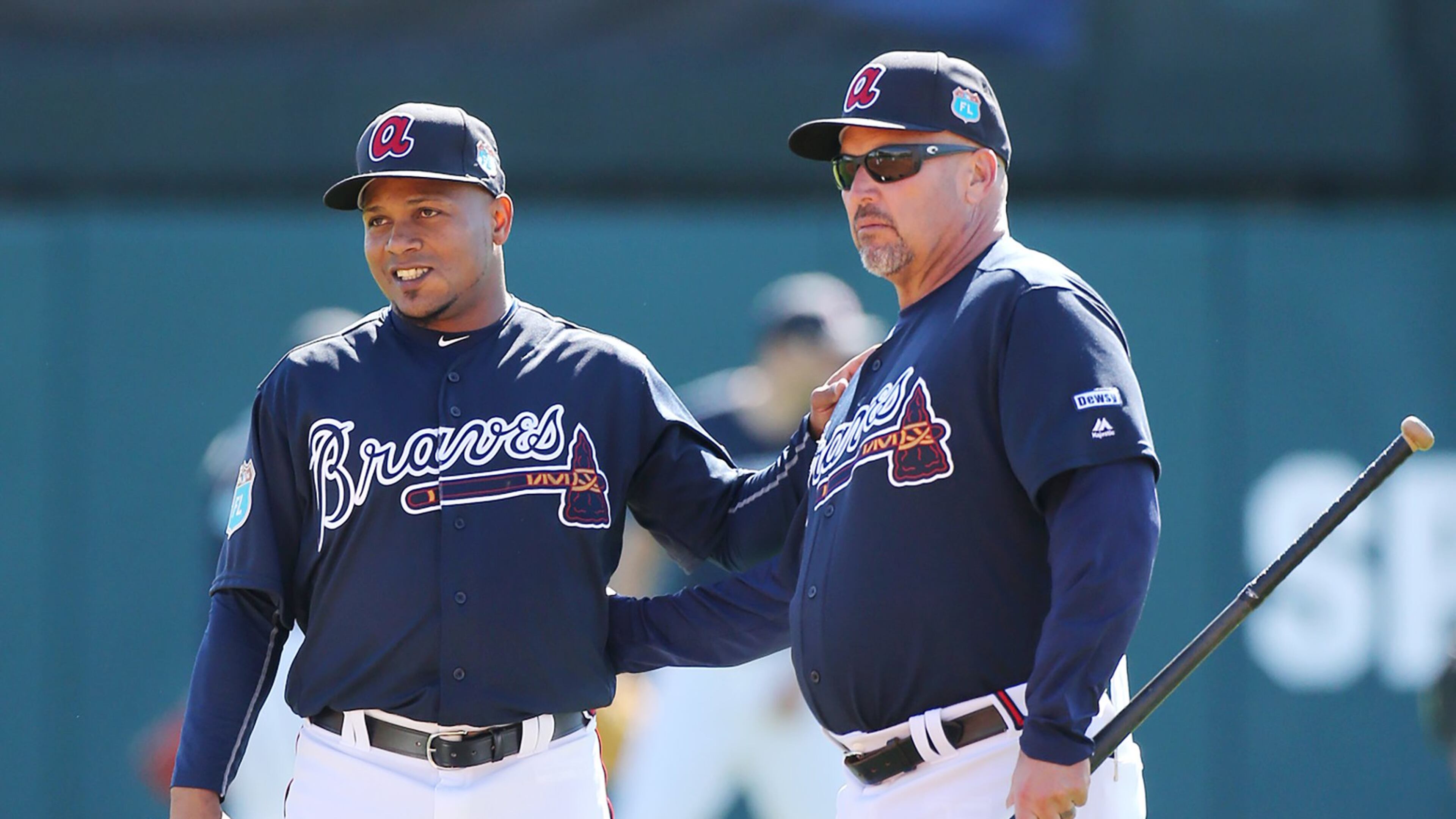 Braves shortstop Erick Aybar (left) chats with manager Fredi Gonzalez during Friday’s spring-training workout. (Curtis Compton / ccompton@ajc.com)
