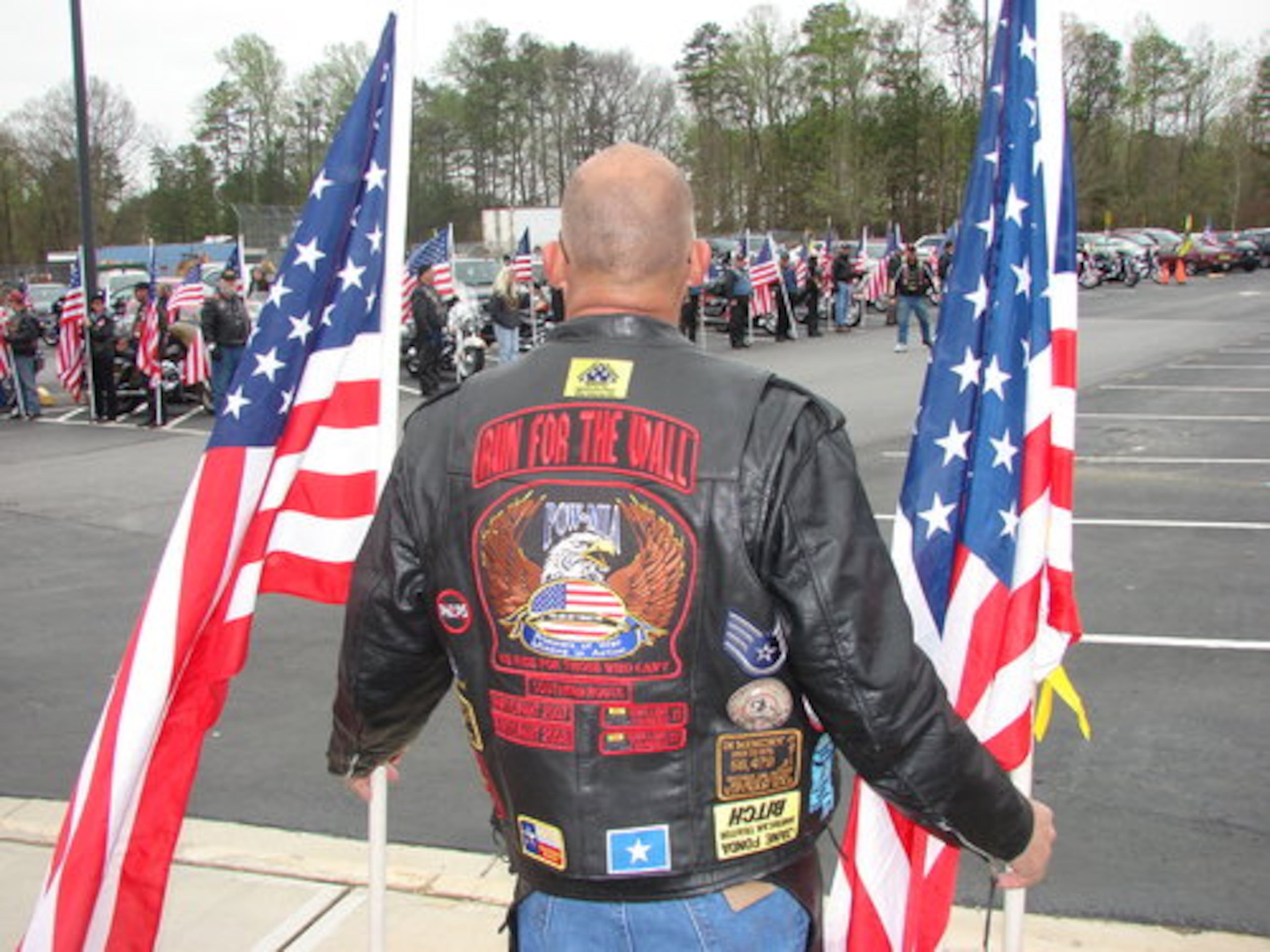 Robby Robertson of Hoschton waits with others for the arrival of the Ayers family Sunday at Shiloh High School. Also attending the ceremony was the family of fellow Georgian Matthew Phillips, killed in the same attack.