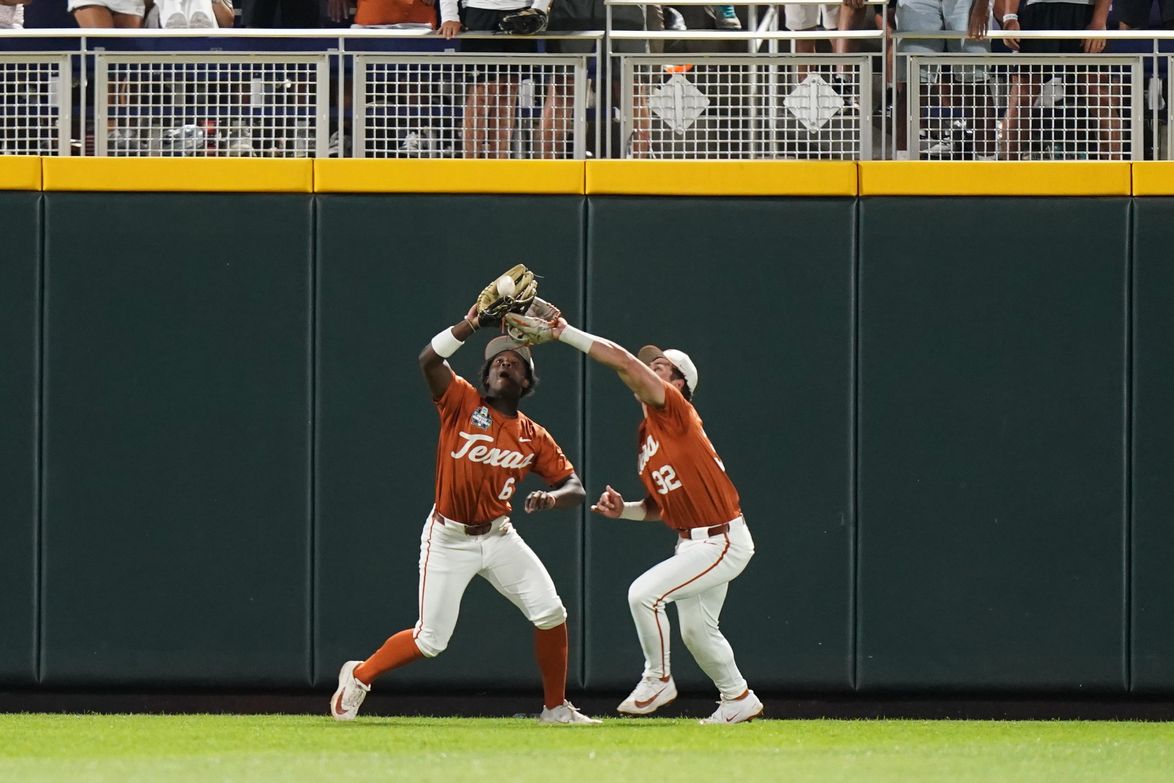 Texas outfielder Anthony Pack Jr. (6) makes the catch in front of outfielder Maddox Monsour (32) during an NCAA baseball College World Series elimination game against Georgia, Tuesday, June 16, 2026 in Omaha, Neb. Georgia won 2-0. (AP Photo/Vera Nieuwenhuis)