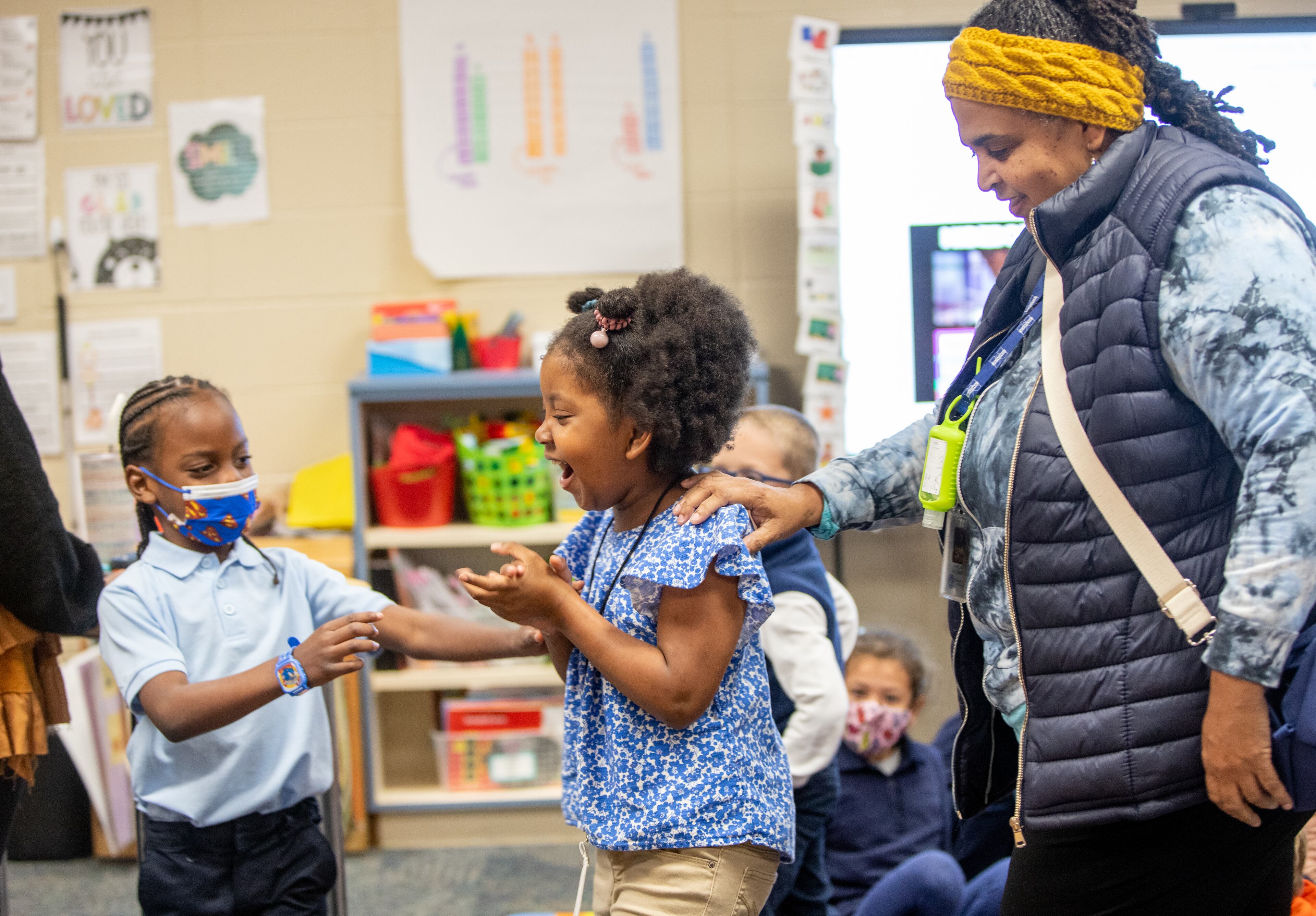 In her classroom with para professional LaGretia Williams, right, Marlie Langford, a blind kindergartener at A.L. Burruss Elementary School in Marietta, participates with her classmates before leaving for one-on-one instruction Tuesday, Nov 9, 2021. (Jenni Girtman for The Atlanta Journal-Constitution)