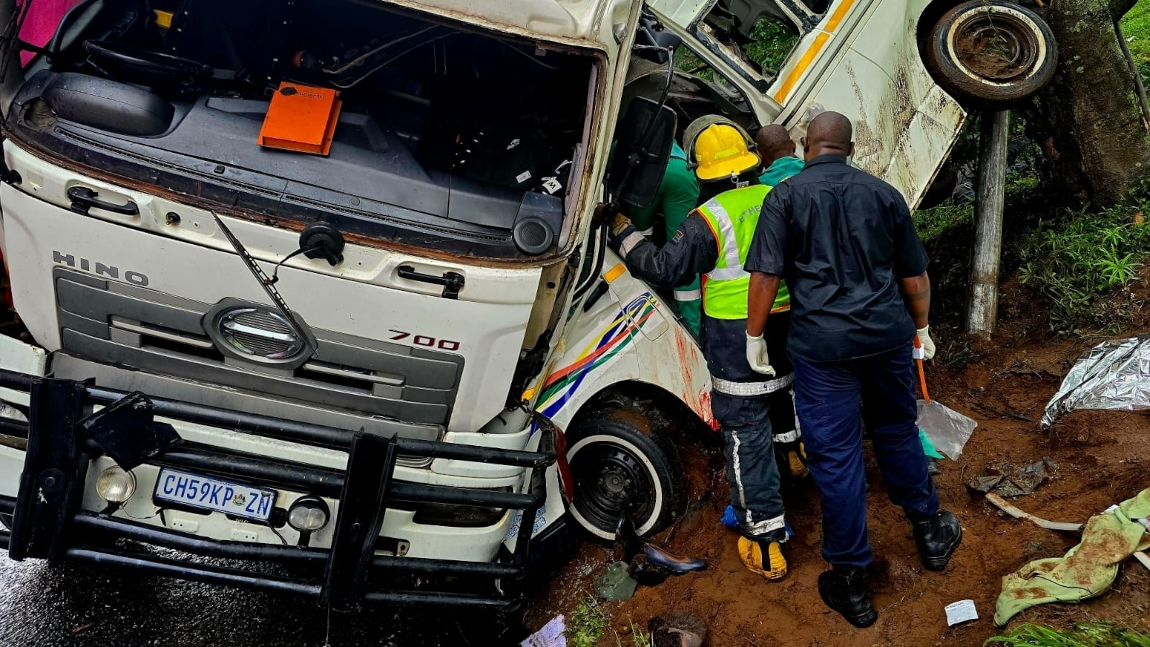In this photo provided by ALS Paramedics on Thursday, Jan. 29, 2026, rescue personnel inspect the site of a collision involving a minibus taxi and a truck, near Durban, South Africa. (ALS Paramedics via AP Photo)