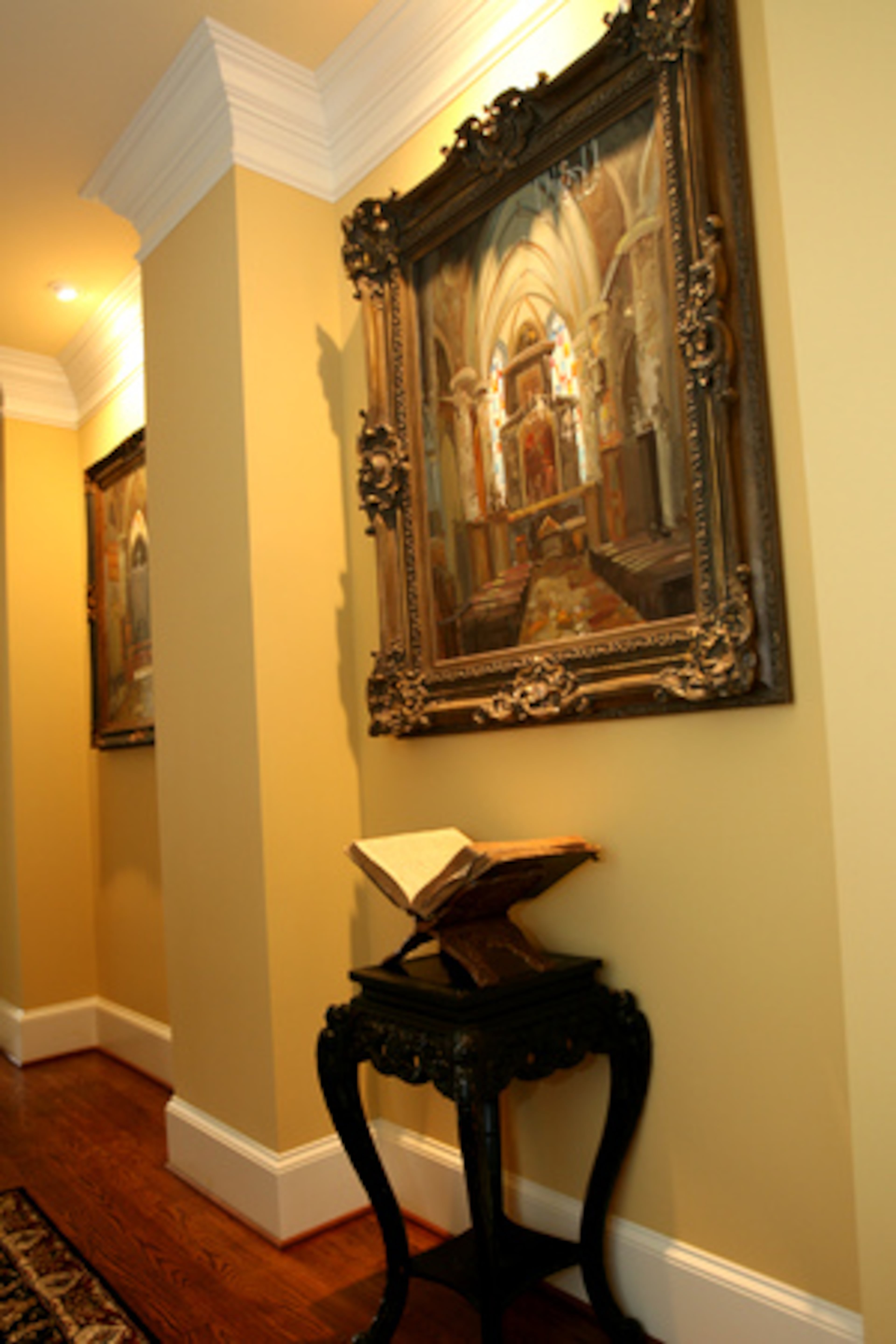 Several oil paintings and a treasured family bible are displayed in the hallway. Todd Roberson bought the three oil paintings for his wife's birthday. The bible is from Marian's side of the family. Her grandparents homesteaded during the Oklahoma land run.