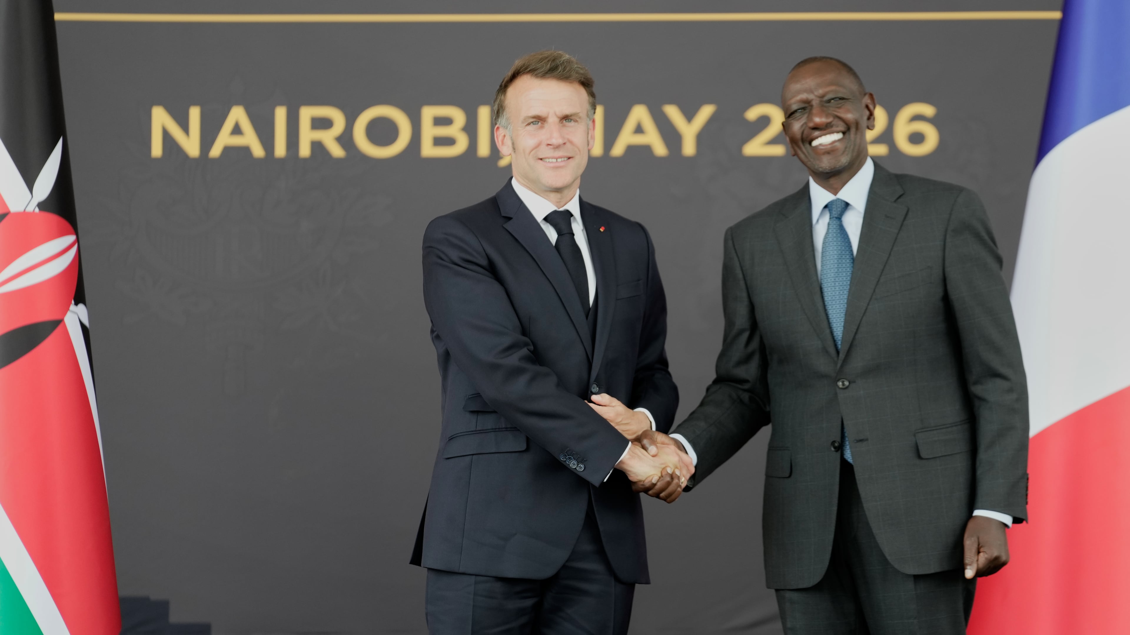 French President Emmanuel Macron, left, and Kenyan President William Ruto shake hands at State House in Nairobi, Kenya, Sunday, May 10, 2026. (AP Photo/Brian Inganga)