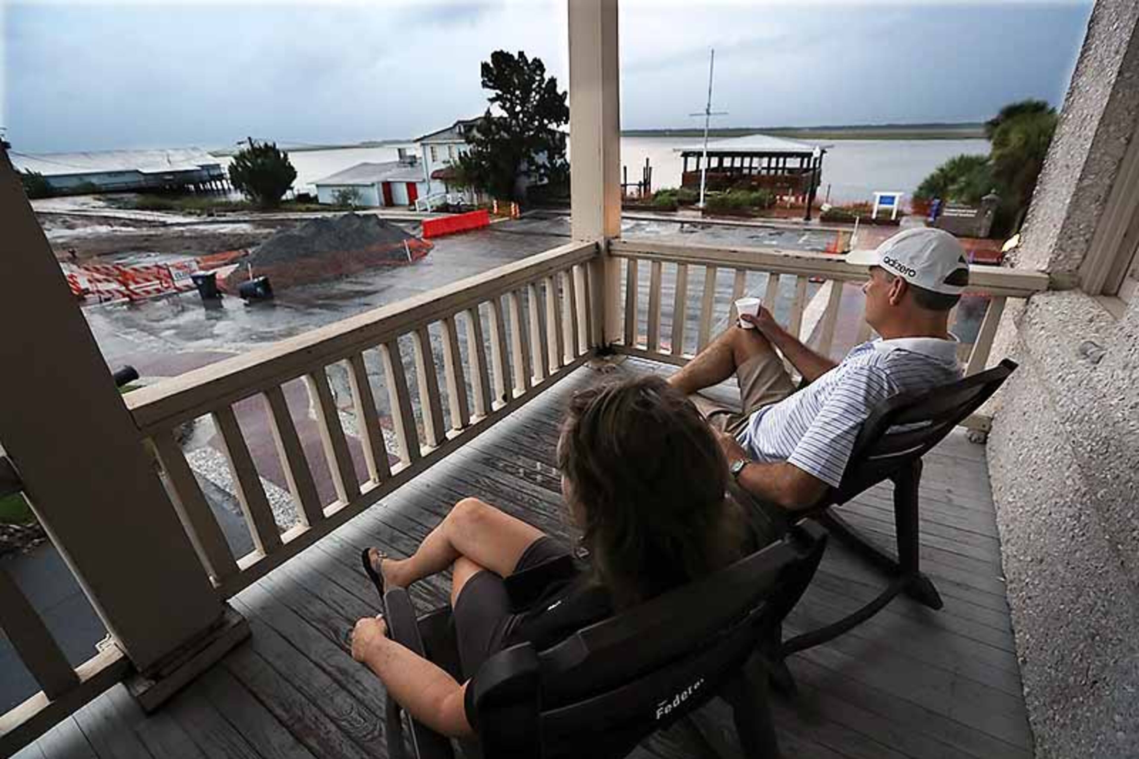 September 4, 2019 St. Mary's: Managers Matt & Janet Kircher, who decided to ride out the storm, watch the approachment of Hurricane Dorian at sunrise from the porch of the Riverview Hotel on Wednesday, Sept. 4, 2019, in St. Mary's. Construction in the street below is continuing repairs from Hurricane Irma. Curtis Compton/ccompton@ajc.com